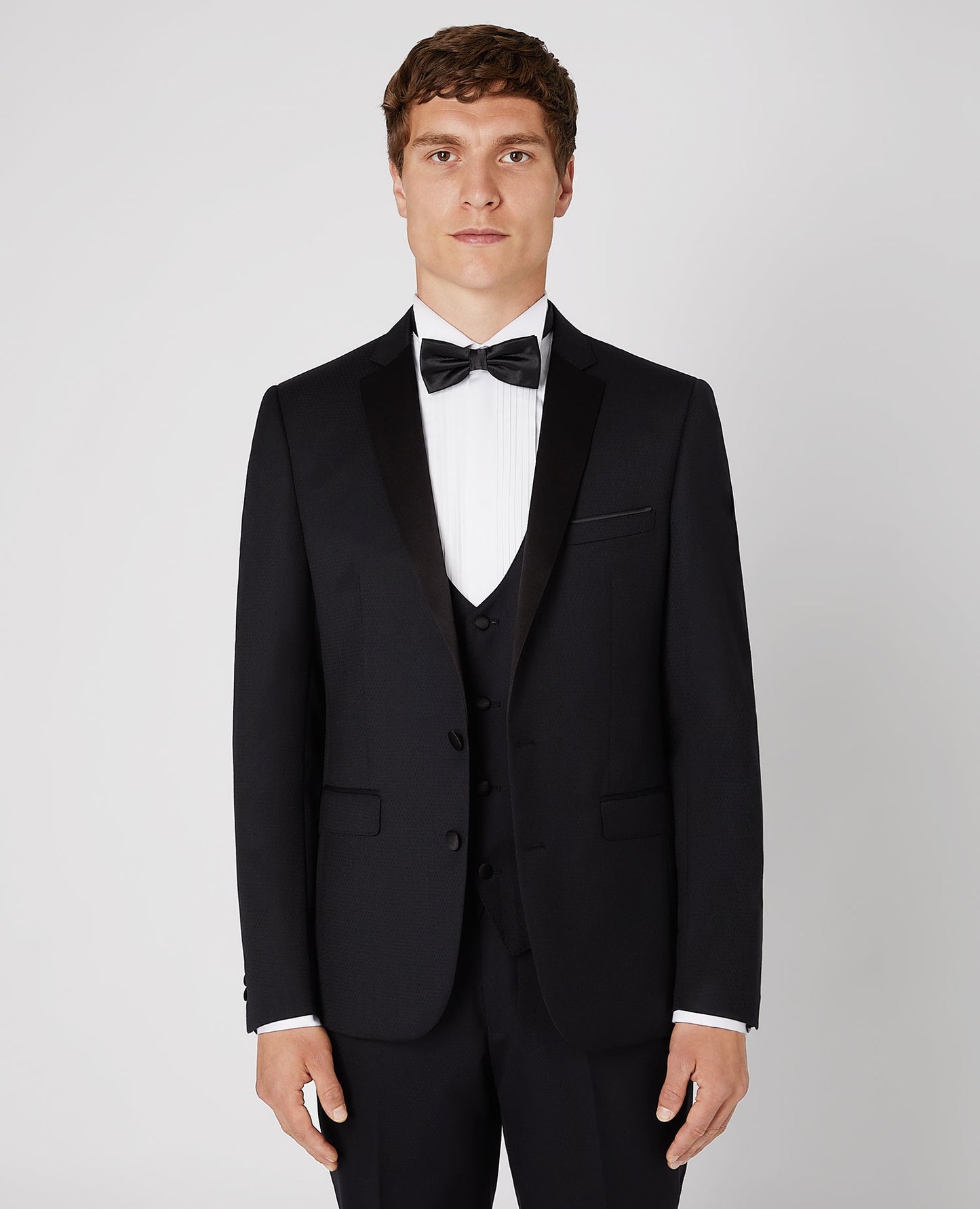Man wearing a black Slim Fit Wool-Rich Mix and Match Dinner Suit