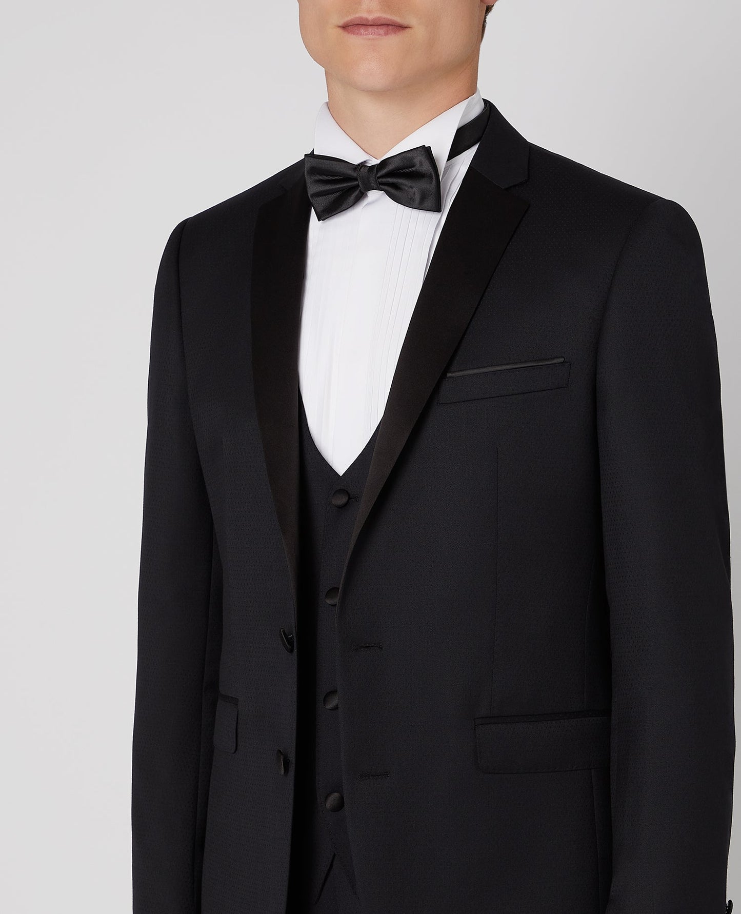 Man wearing a black Slim Fit Wool-Rich Mix and Match Dinner Suit