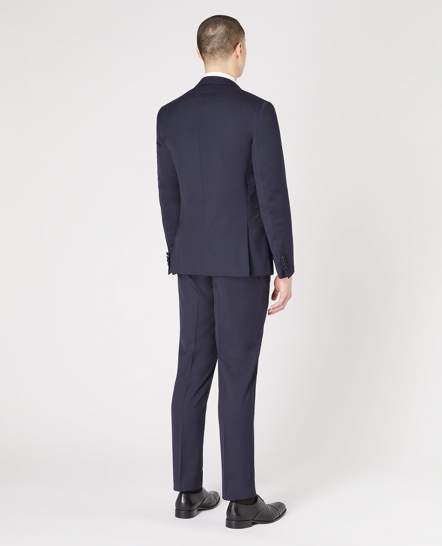 Man wearing a navy Slim Fit Wool-Rich Mix and Match Dinner Suit Jacket
