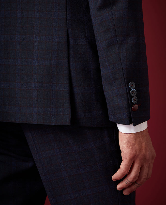 Man wearing a navy Tapered Fit Checked Wool Rich Mix and Match Suit