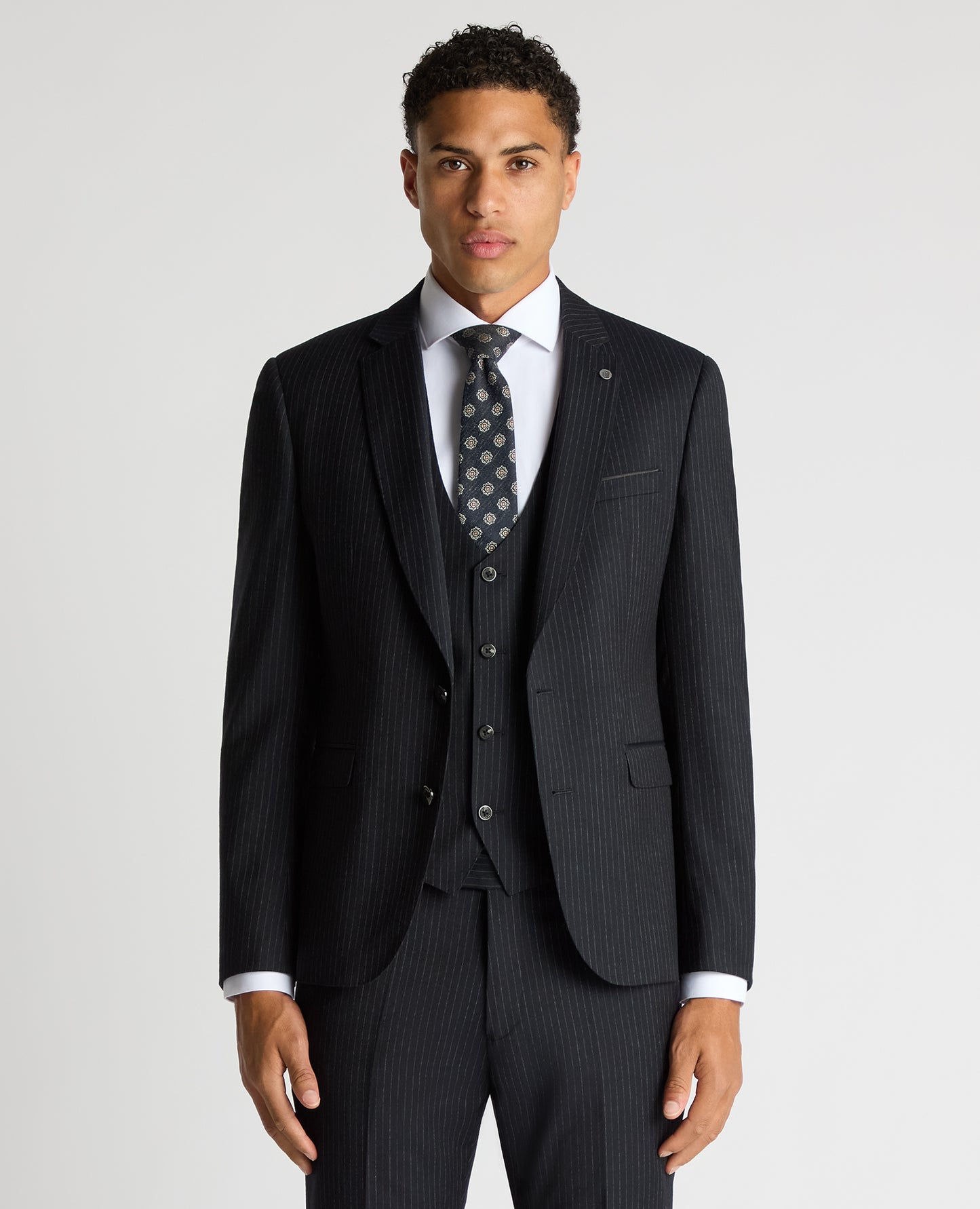 Man wearing a navy Slim Fit Pinstripe Wool Rich Suit
