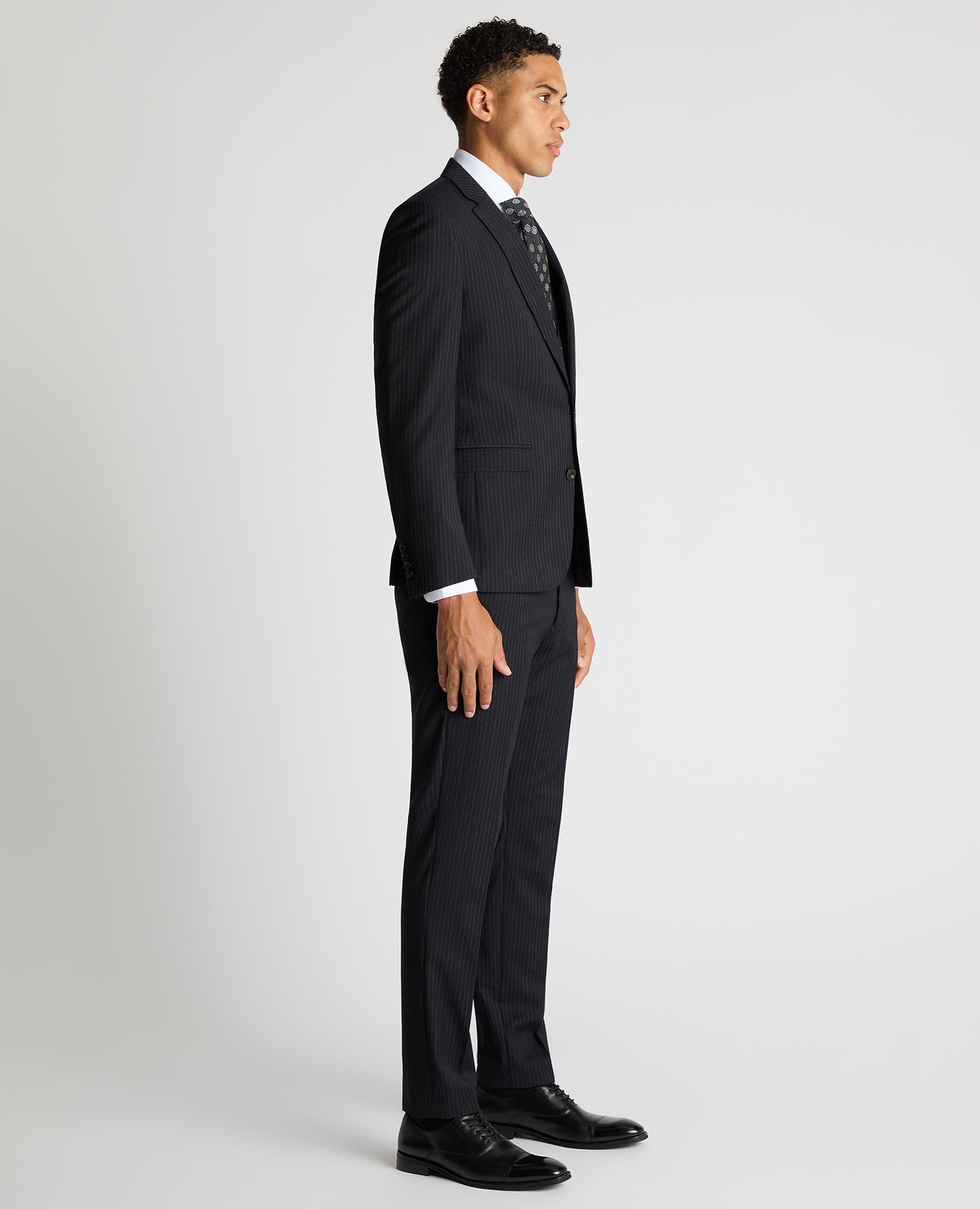 Man wearing a navy Slim Fit Pinstripe Wool Rich Suit