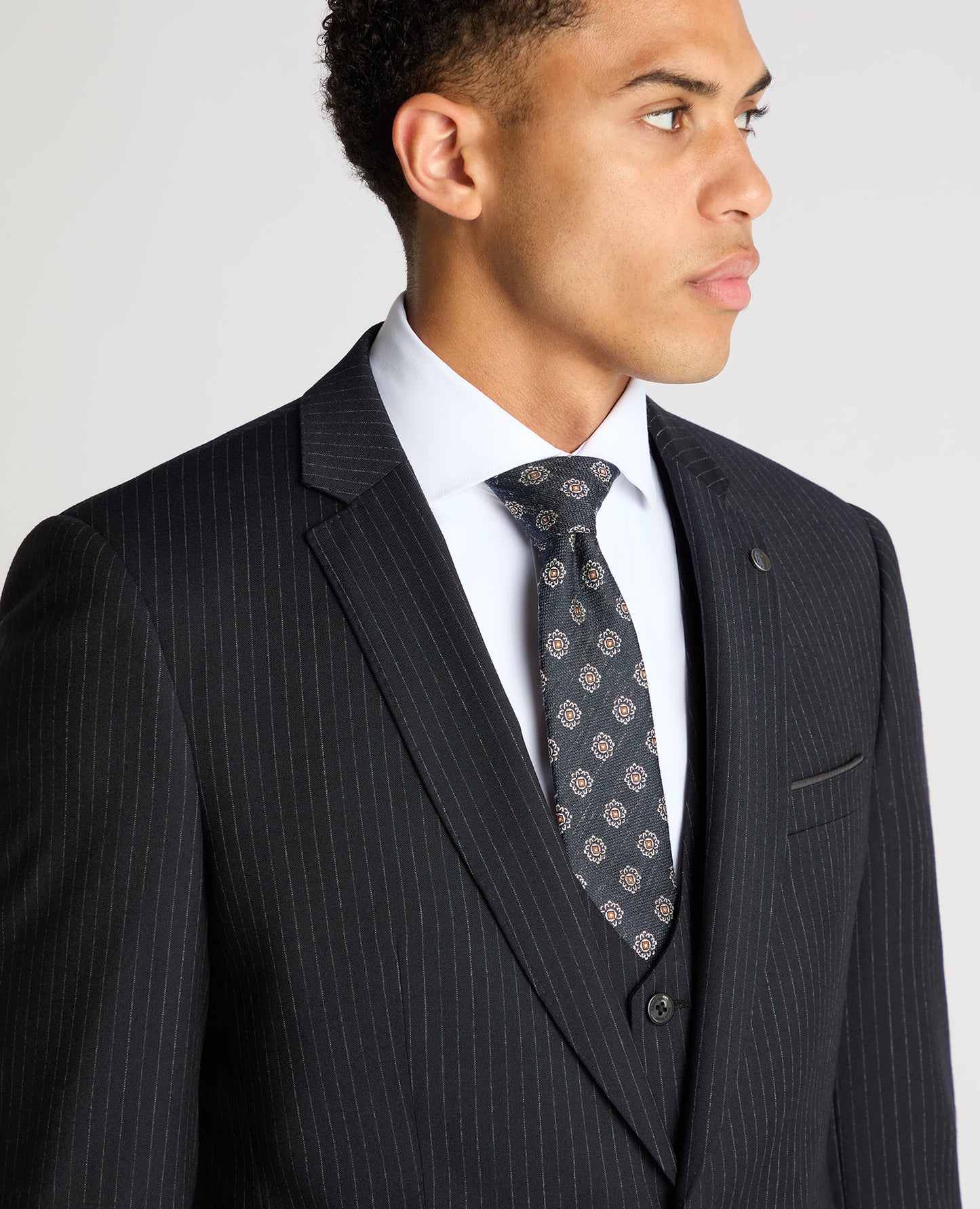 Man wearing a navy Slim Fit Pinstripe Wool Rich Suit