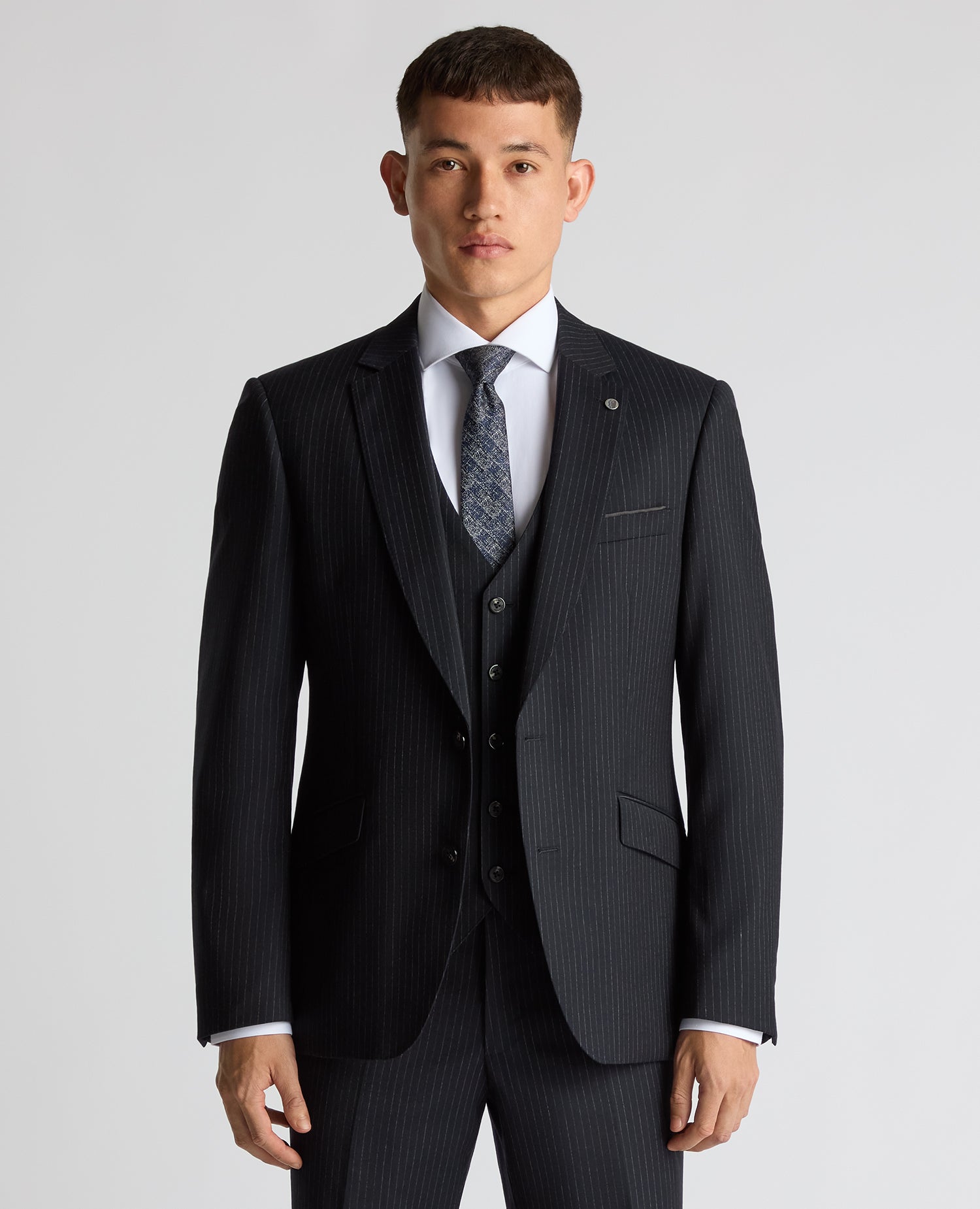 Man wearing a navy Tapered Fit Wool Rich Suit