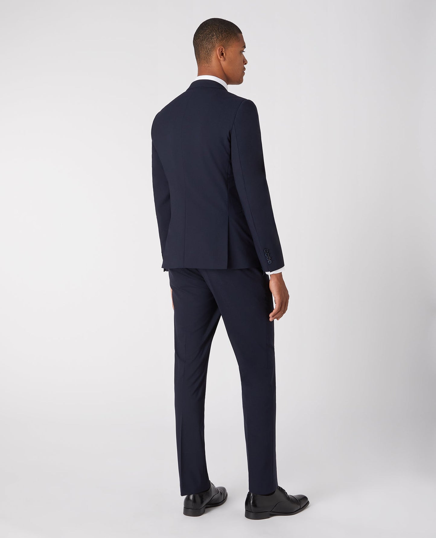 Man wearing a navy Slim Fit Wool-Rich Stretch Mix and Match Suit Jacket