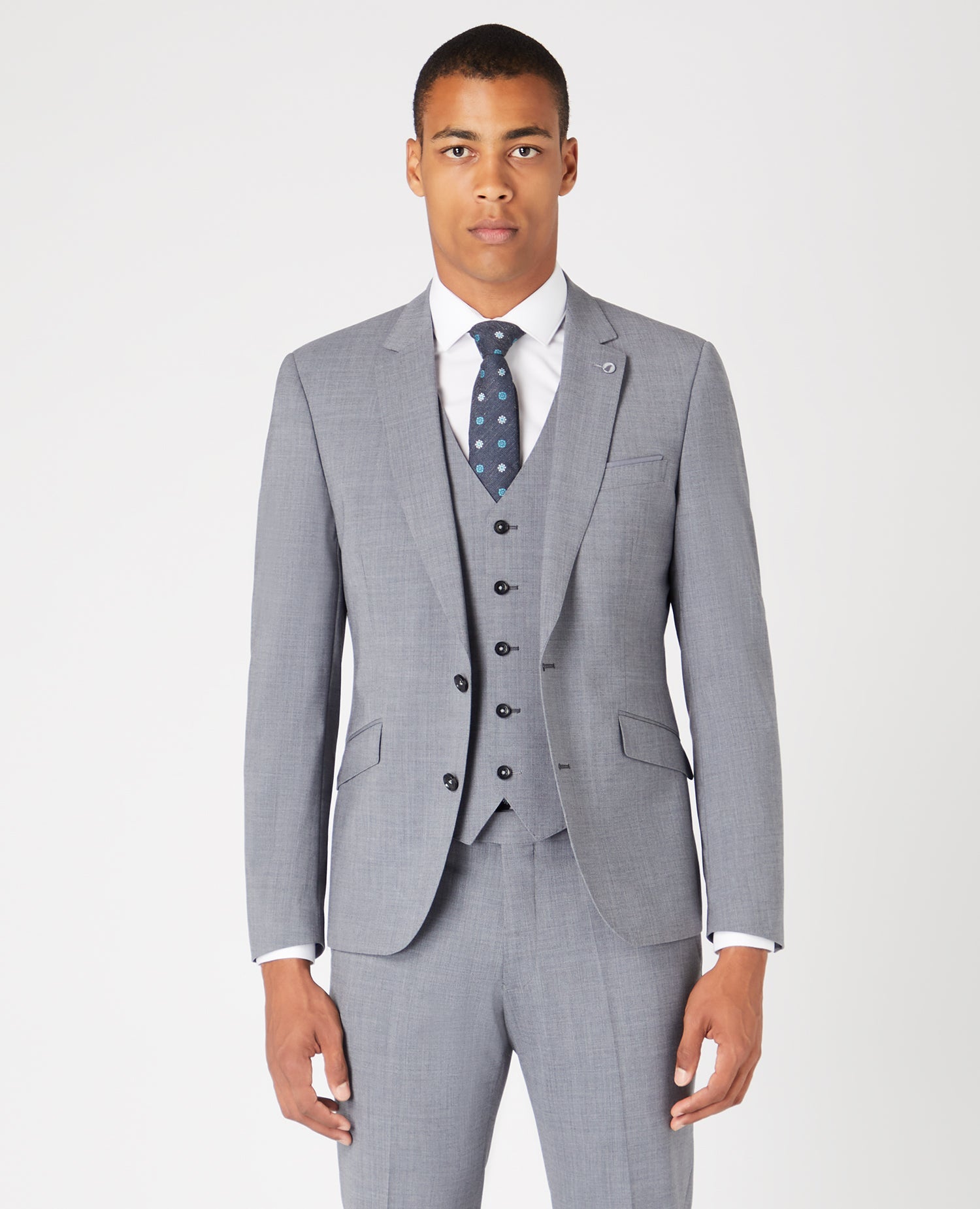 Man wearing a grey Tapered Fit Wool-Rich Stretch Mix and Match Suit Jacket
