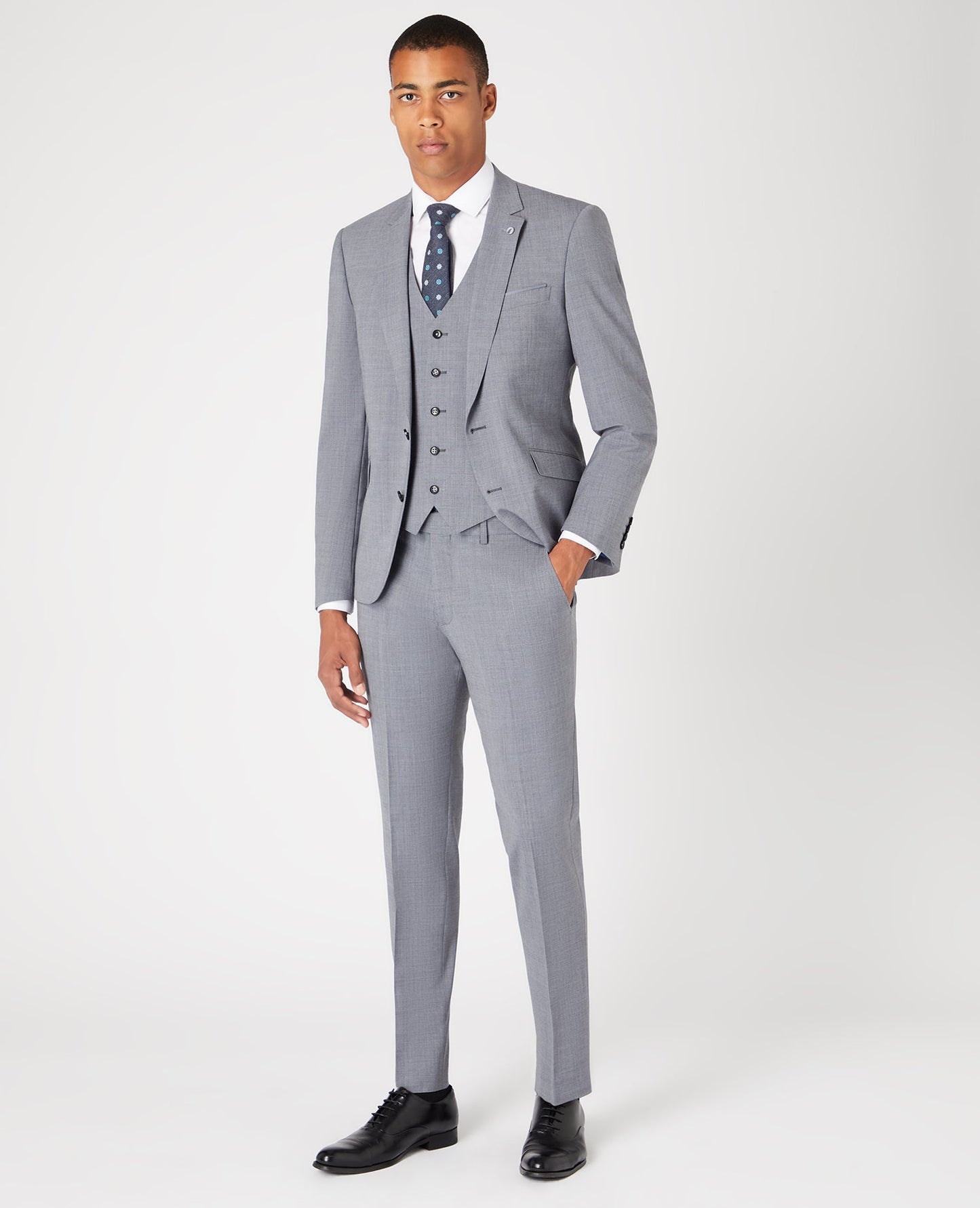 Man wearing a grey Tapered Fit Wool-Rich Stretch Mix and Match Suit Jacket