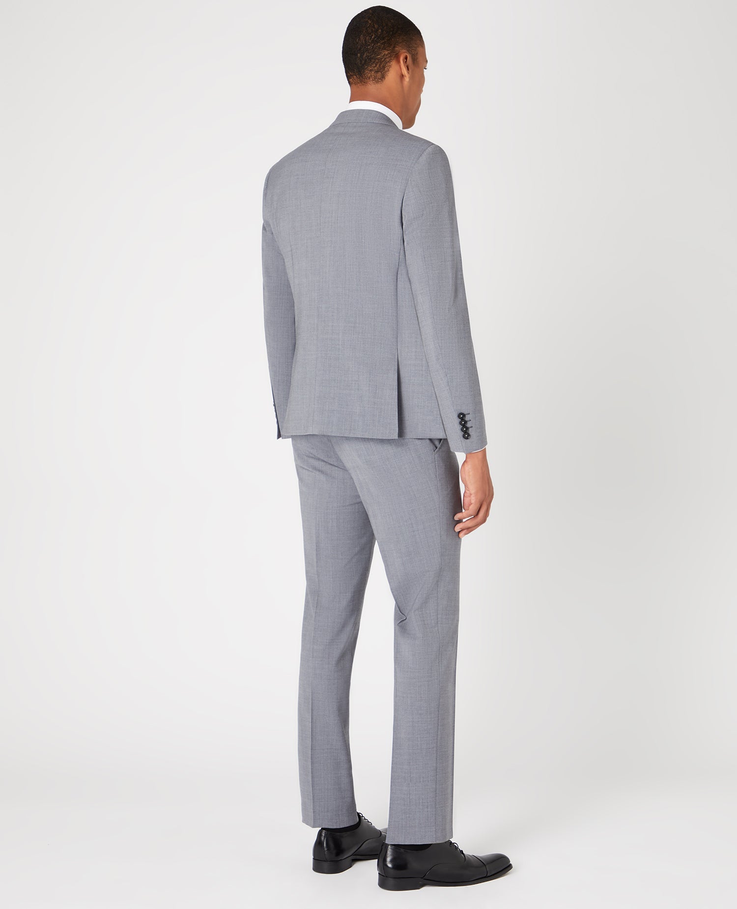 Man wearing a grey Tapered Fit Wool-Rich Stretch Mix and Match Suit Jacket