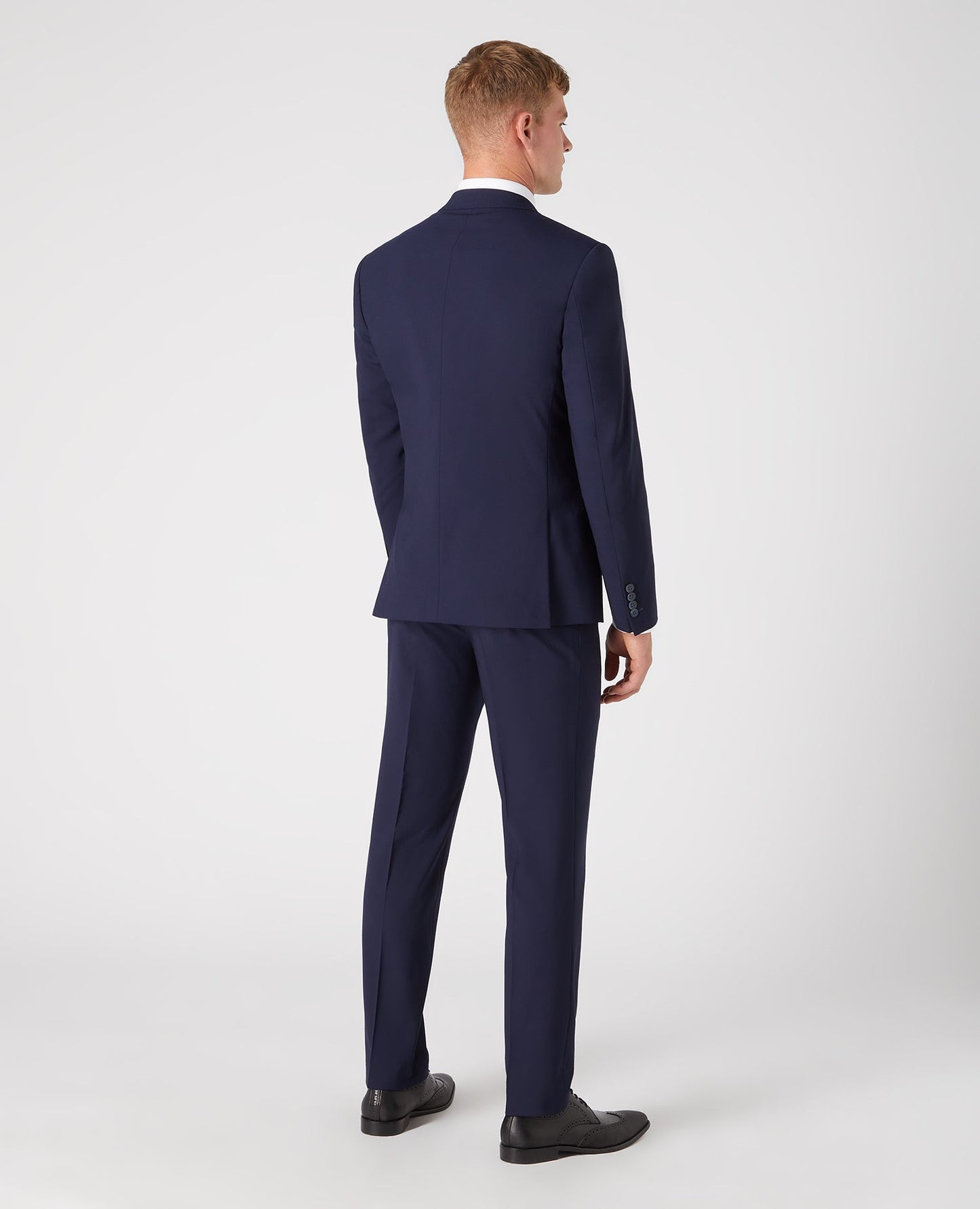 Man wearing a navy Tapered Fit Wool-Rich Stretch Mix and Match
