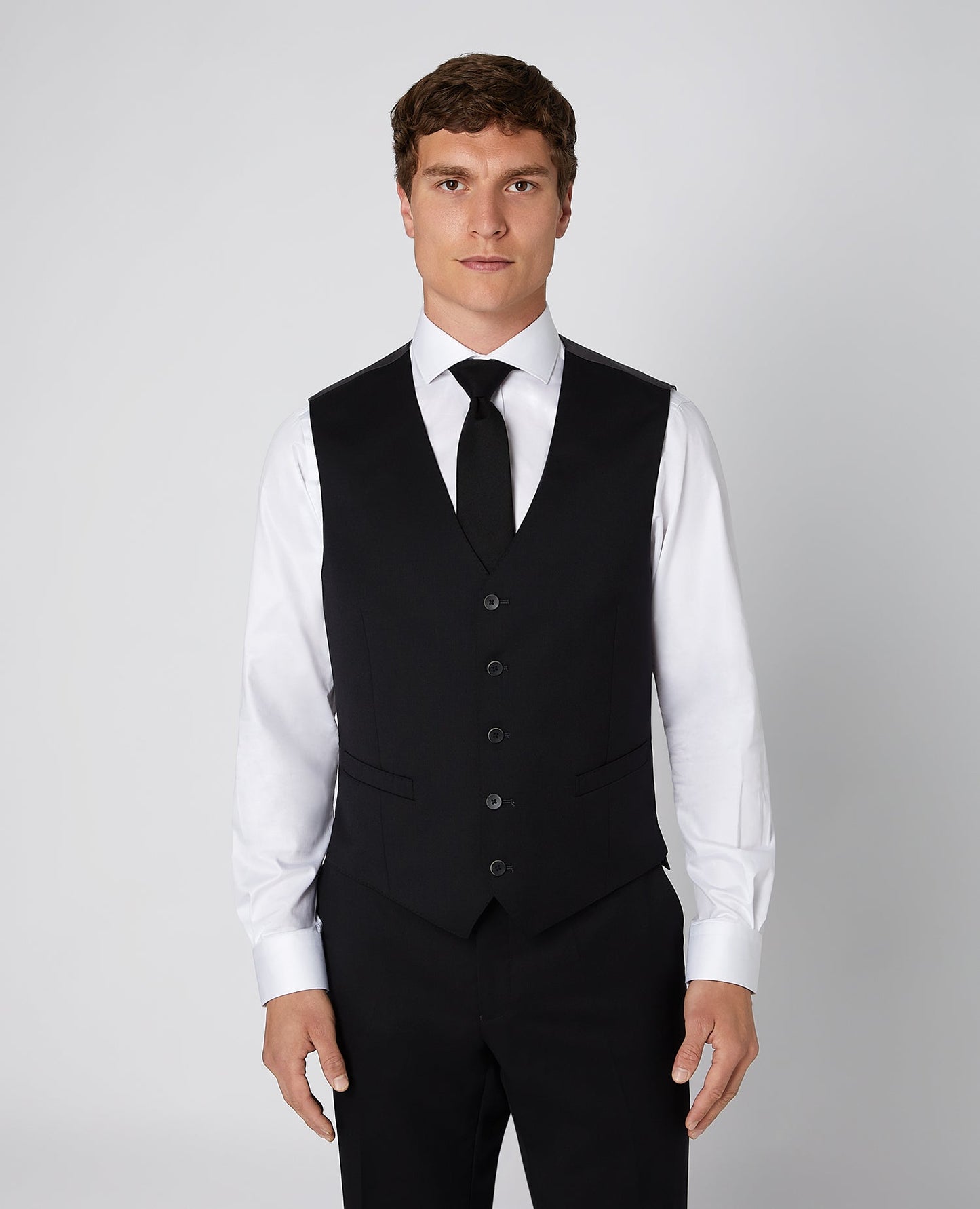 Man wearing a black Tapered Fit Wool-Blend Stretch Mix and Match Suit Waistcoat