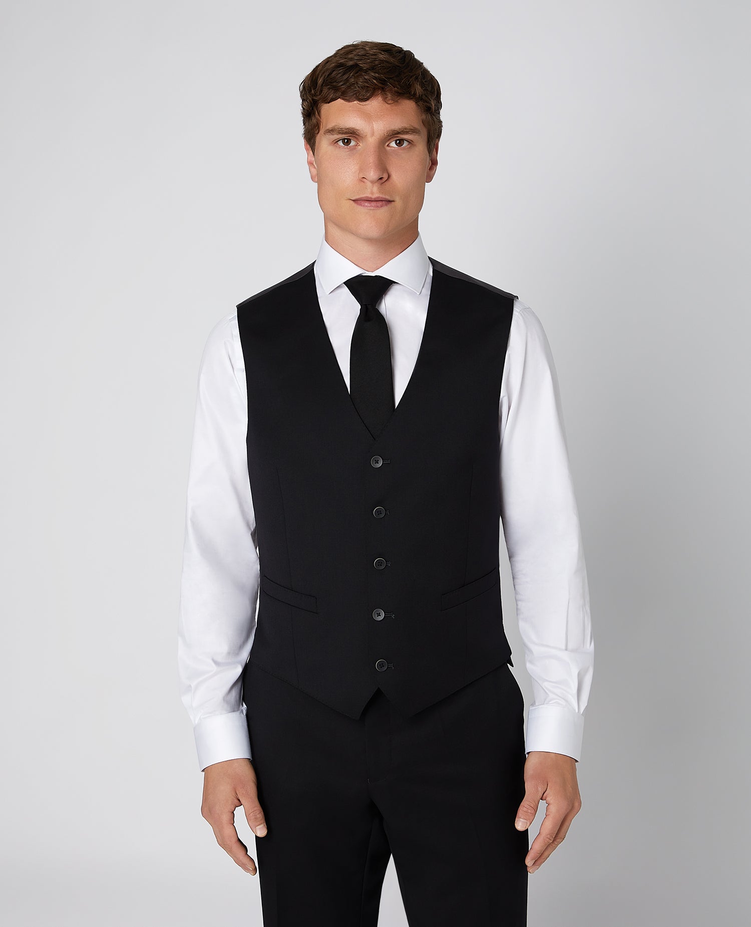 Man wearing a black Tapered Fit Wool-Blend Stretch Mix and Match Suit Waistcoat