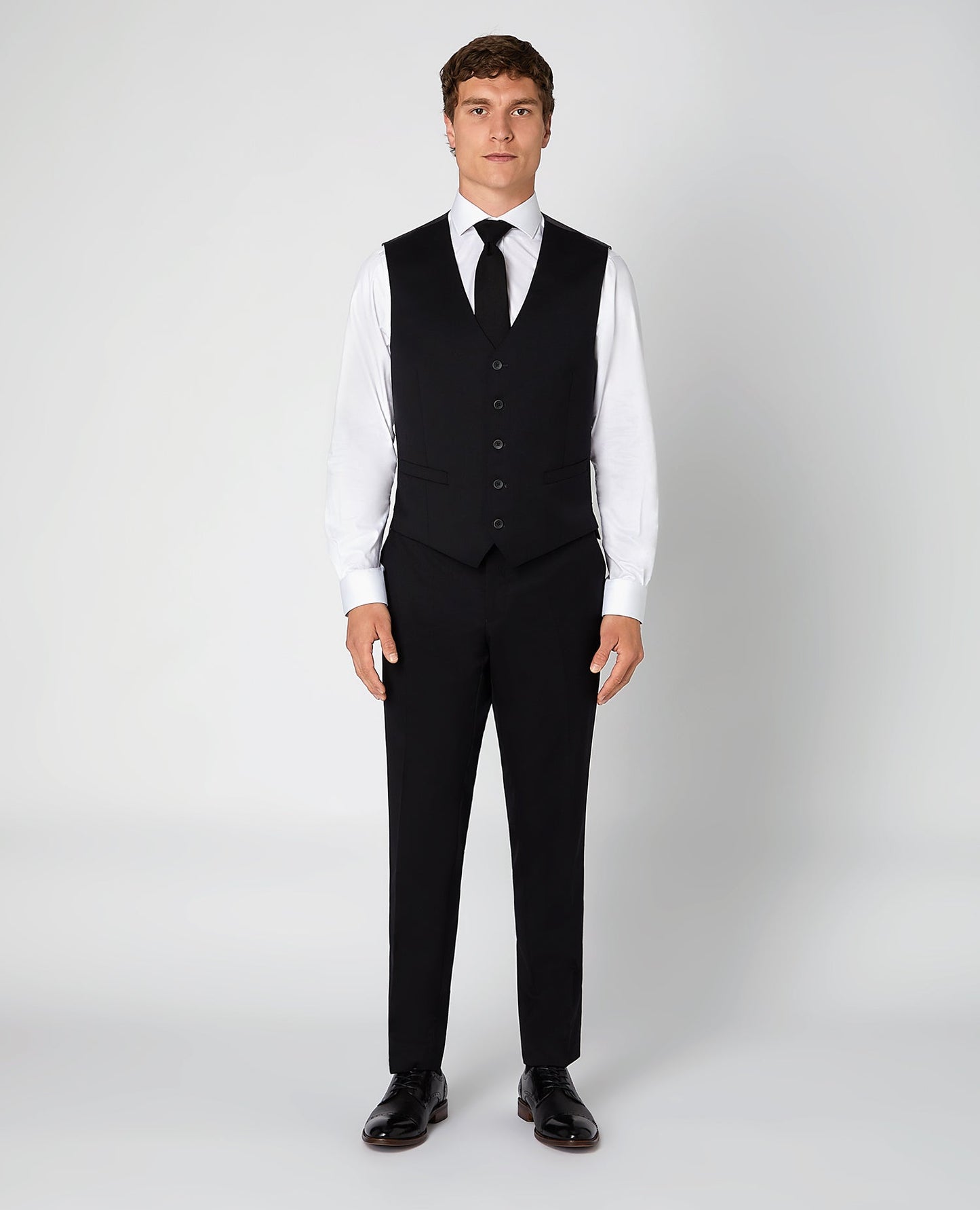 Man wearing a black Tapered Fit Wool-Blend Stretch Mix and Match Suit Waistcoat