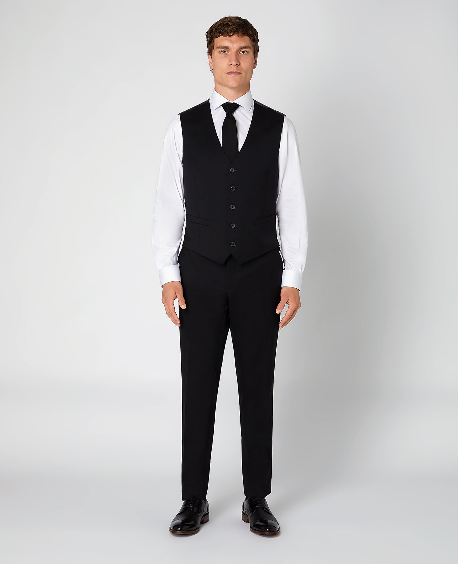 Man wearing a black Tapered Fit Wool-Blend Stretch Mix and Match Suit Waistcoat