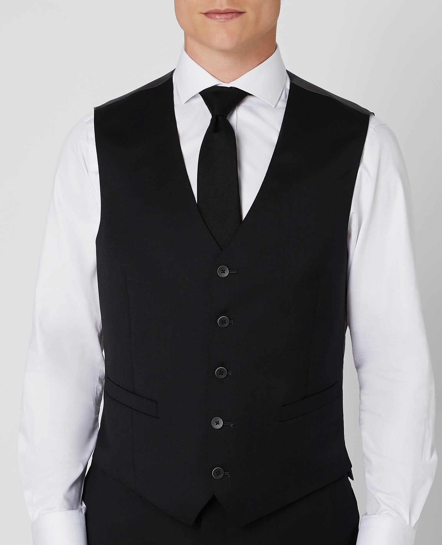 Man wearing a black Tapered Fit Wool-Blend Stretch Mix and Match Suit Waistcoat