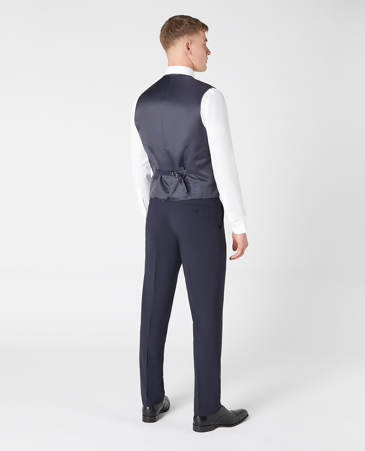 Man wearing a navy Tapered fit wool blend stretch mix and match suit waistcoat