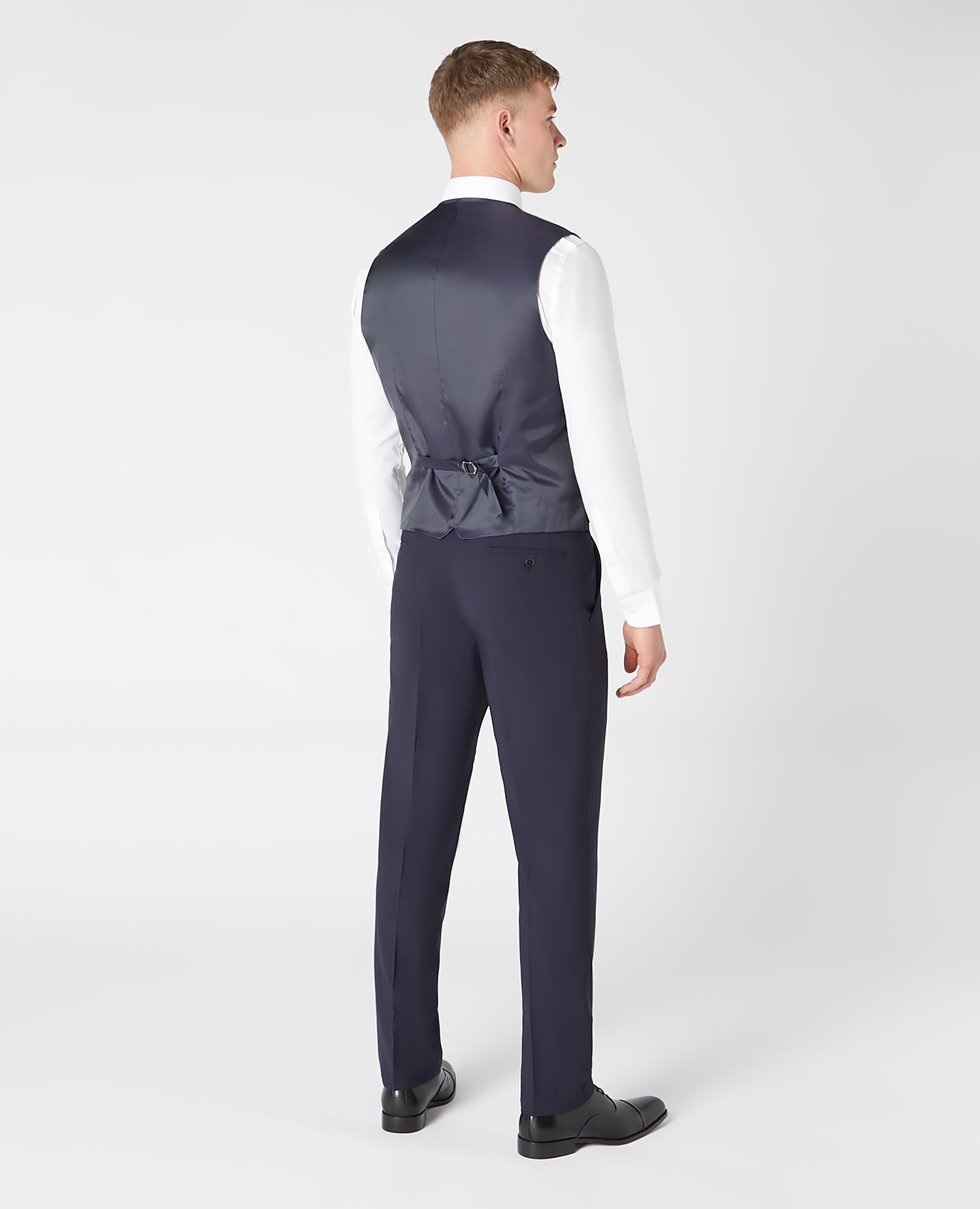 Man wearing a navy Tapered fit wool blend stretch mix and match suit waistcoat