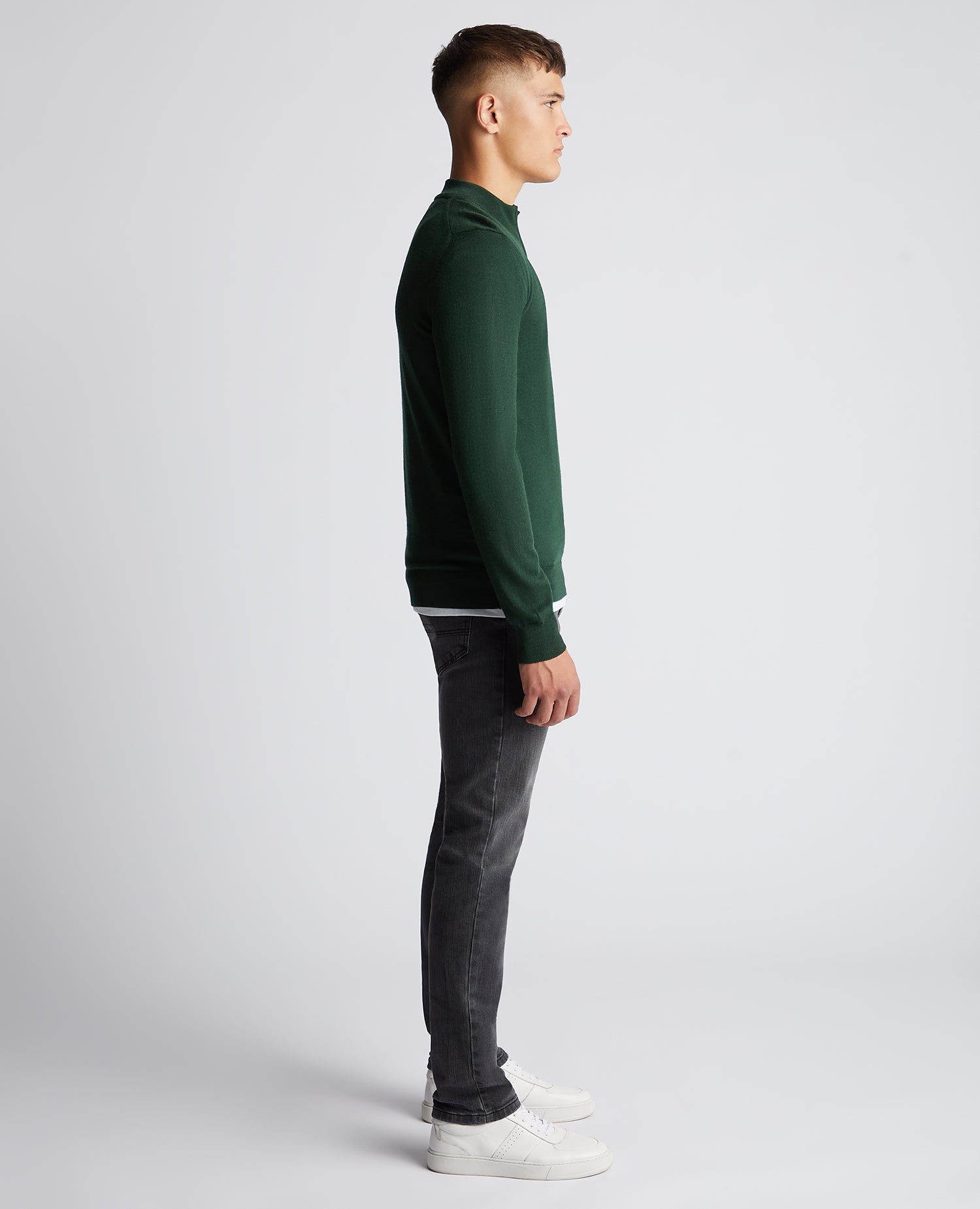 Man wearing a green Tapered Fit Merino Wool-Blend Half Zip Sweater