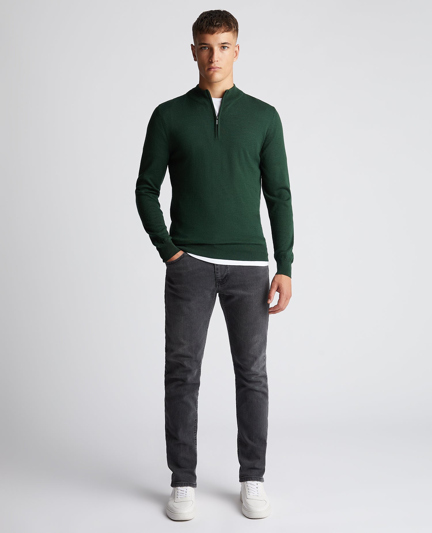 Man wearing a green Tapered Fit Merino Wool-Blend Half Zip Sweater