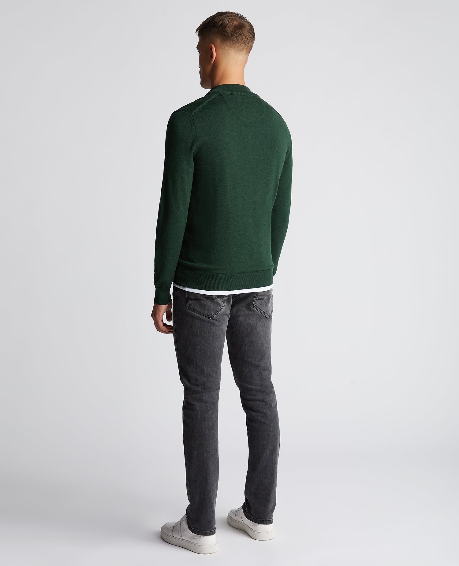 Man wearing a green Tapered Fit Merino Wool-Blend Half Zip Sweater
