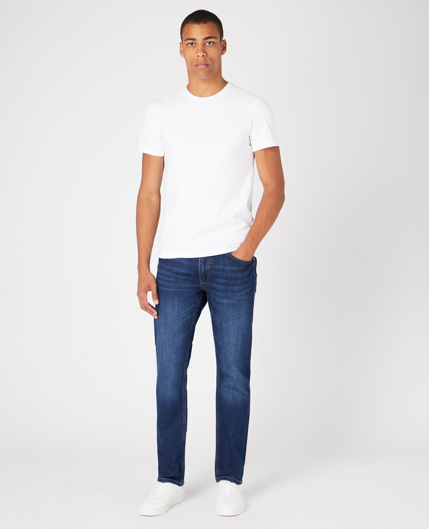 Man wearing a navy Straight Leg Cotton-Stretch Jeans