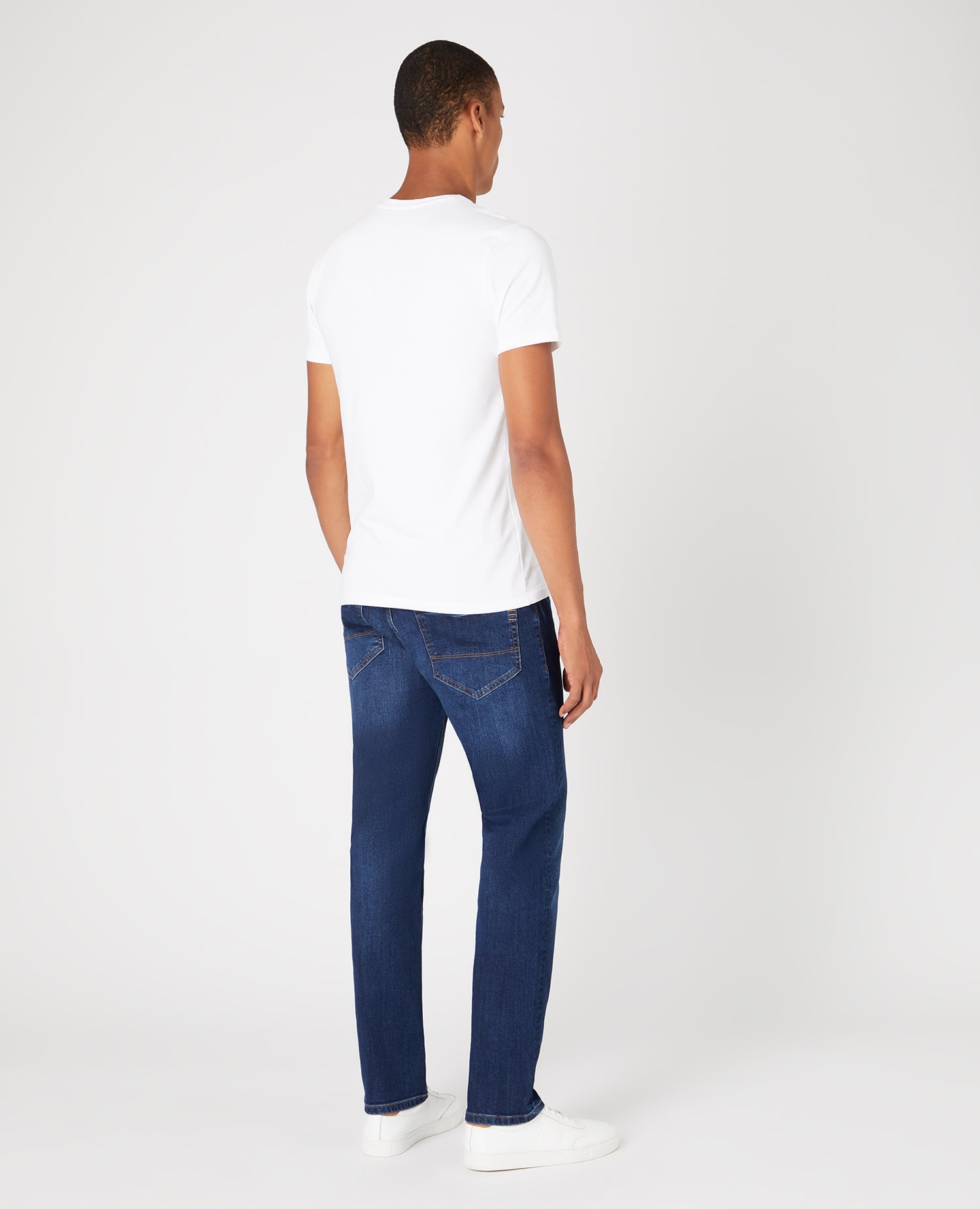 Man wearing a navy Straight Leg Cotton-Stretch Jeans