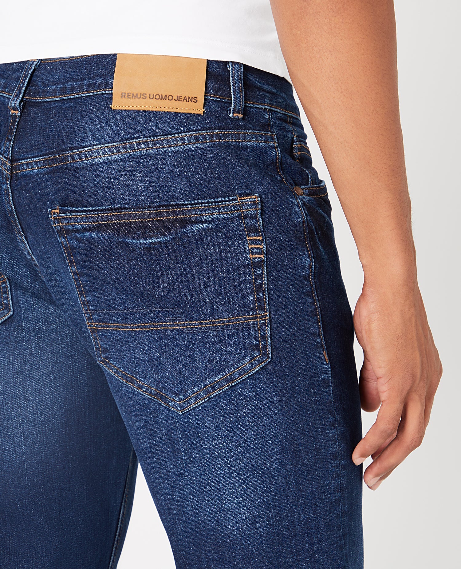 Man wearing a navy Straight Leg Cotton-Stretch Jeans