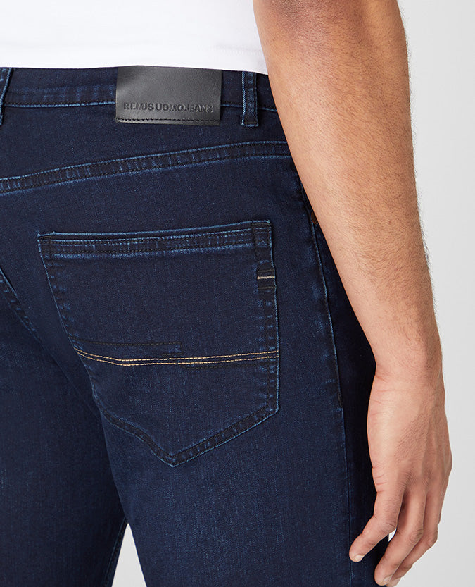 Man wearing a navy Rogan Straight Leg Cotton Power Stretch Jeans