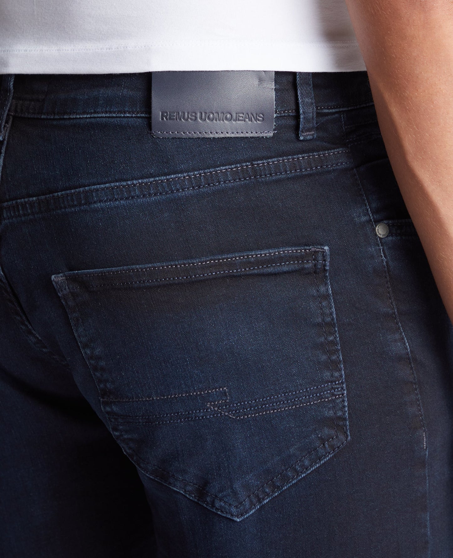 Man wearing a navy Apollo Slim Leg Cotton Power Stretch Jeans