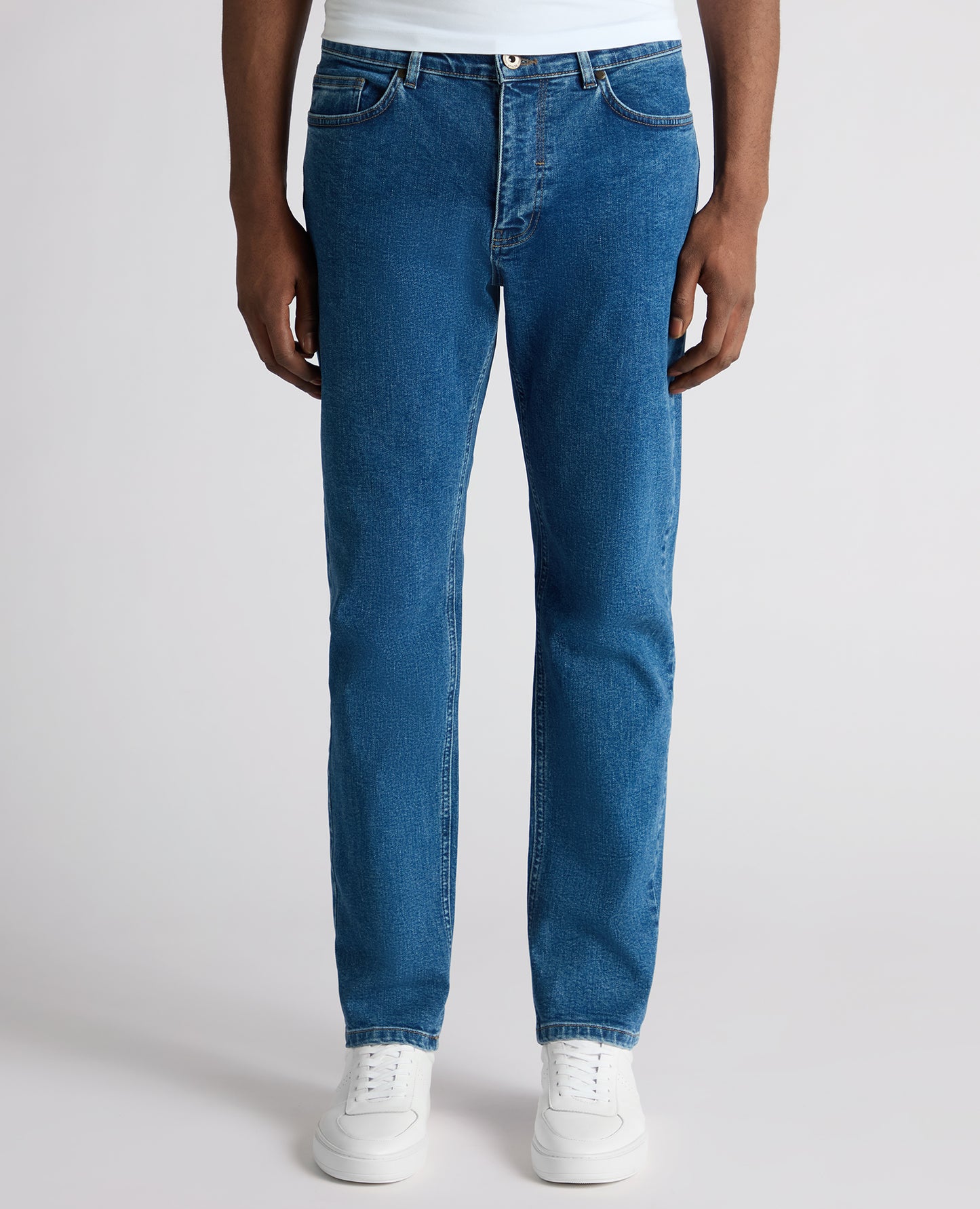 Man wearing a blue Roman Modern Straight Fit Cotton-Stretch Jean