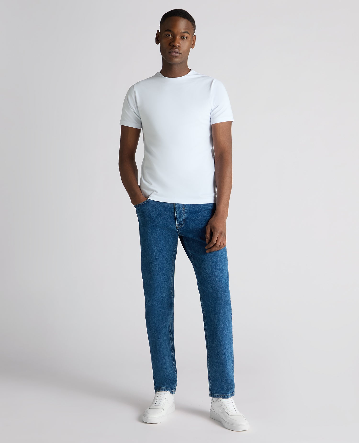 Man wearing a blue Roman Modern Straight Fit Cotton-Stretch Jean