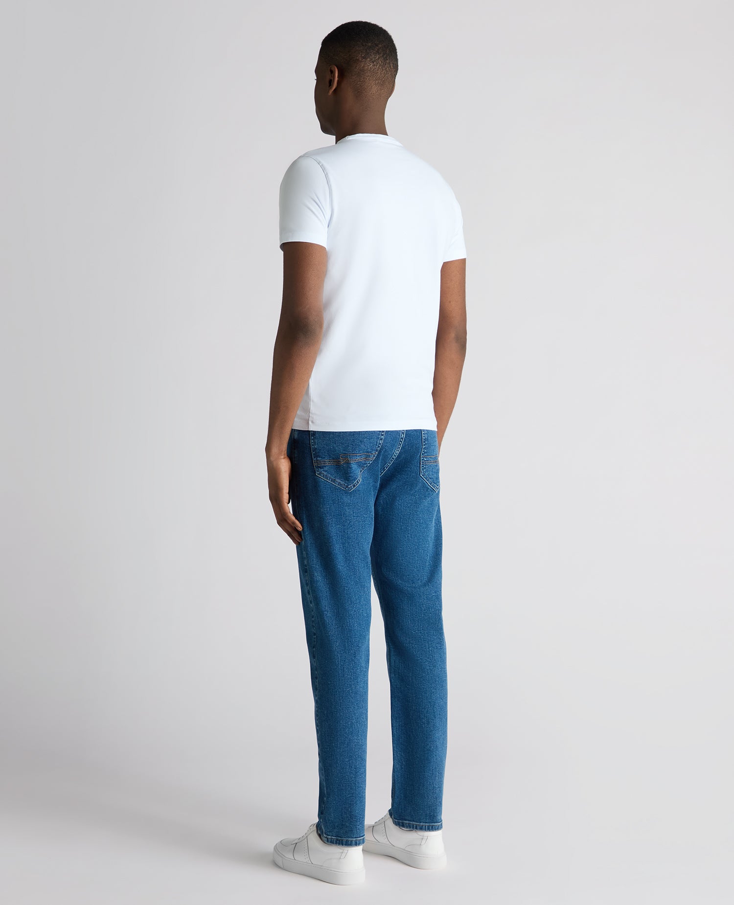 Man wearing a blue Roman Modern Straight Fit Cotton-Stretch Jean