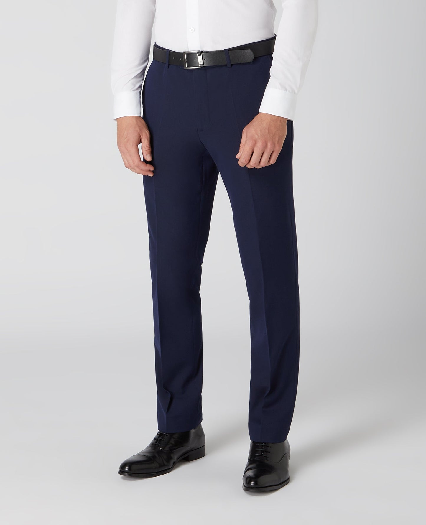 Man wearing a navy Tapered Fit Formal Trousers