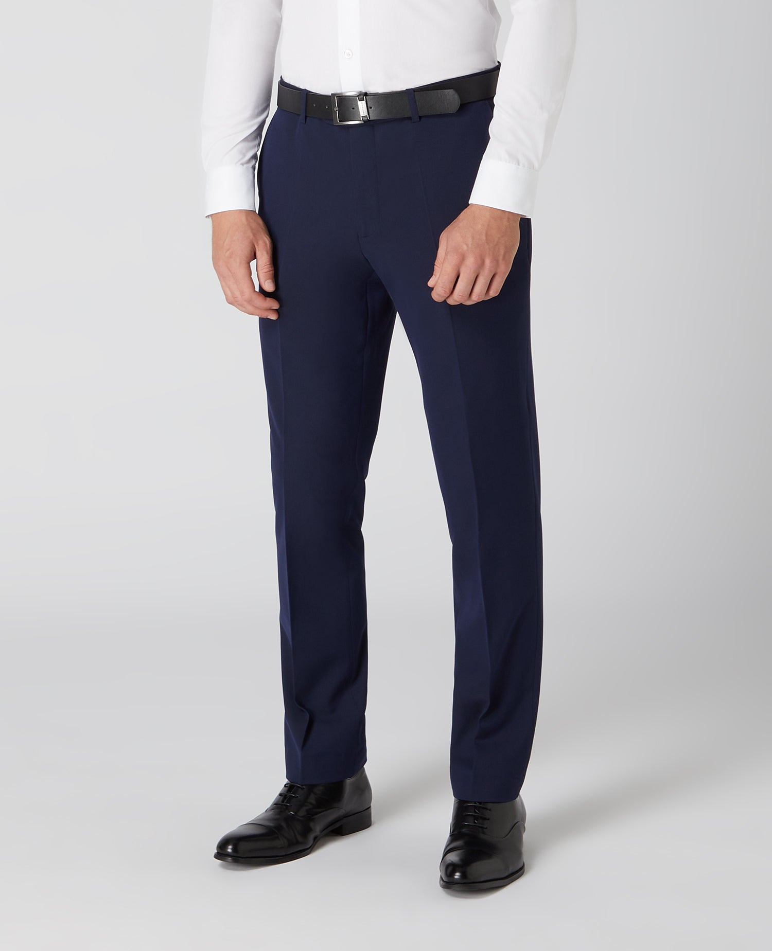 Man wearing a navy Tapered Fit Formal Trousers
