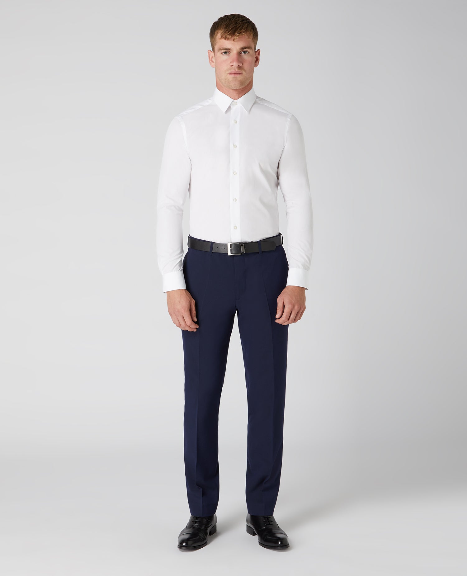 Man wearing a navy Tapered Fit Formal Trousers