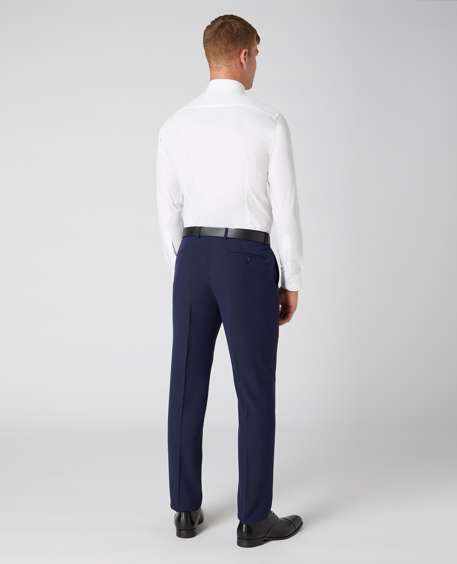 Man wearing a navy Tapered Fit Formal Trousers