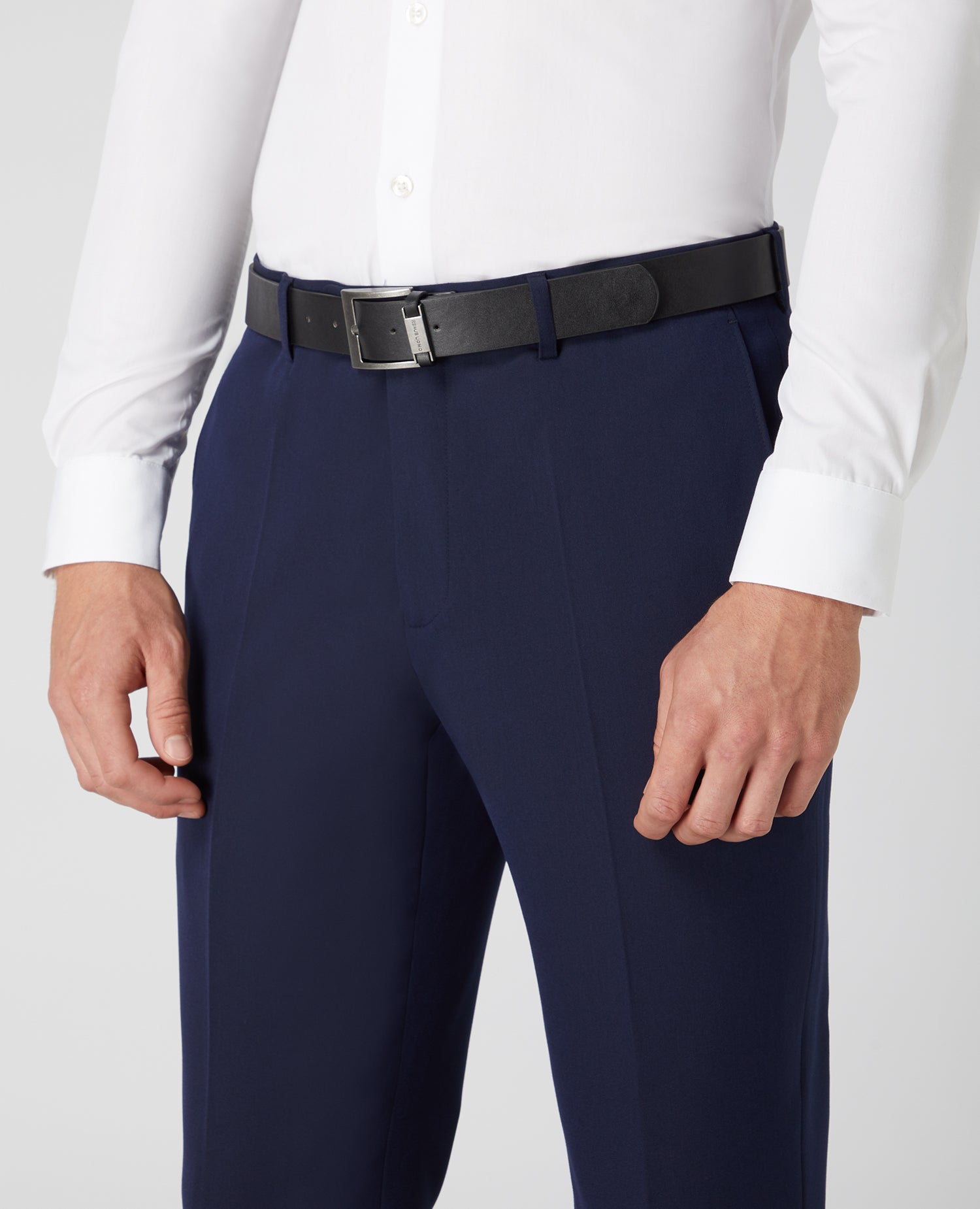 Man wearing a navy Tapered Fit Formal Trousers