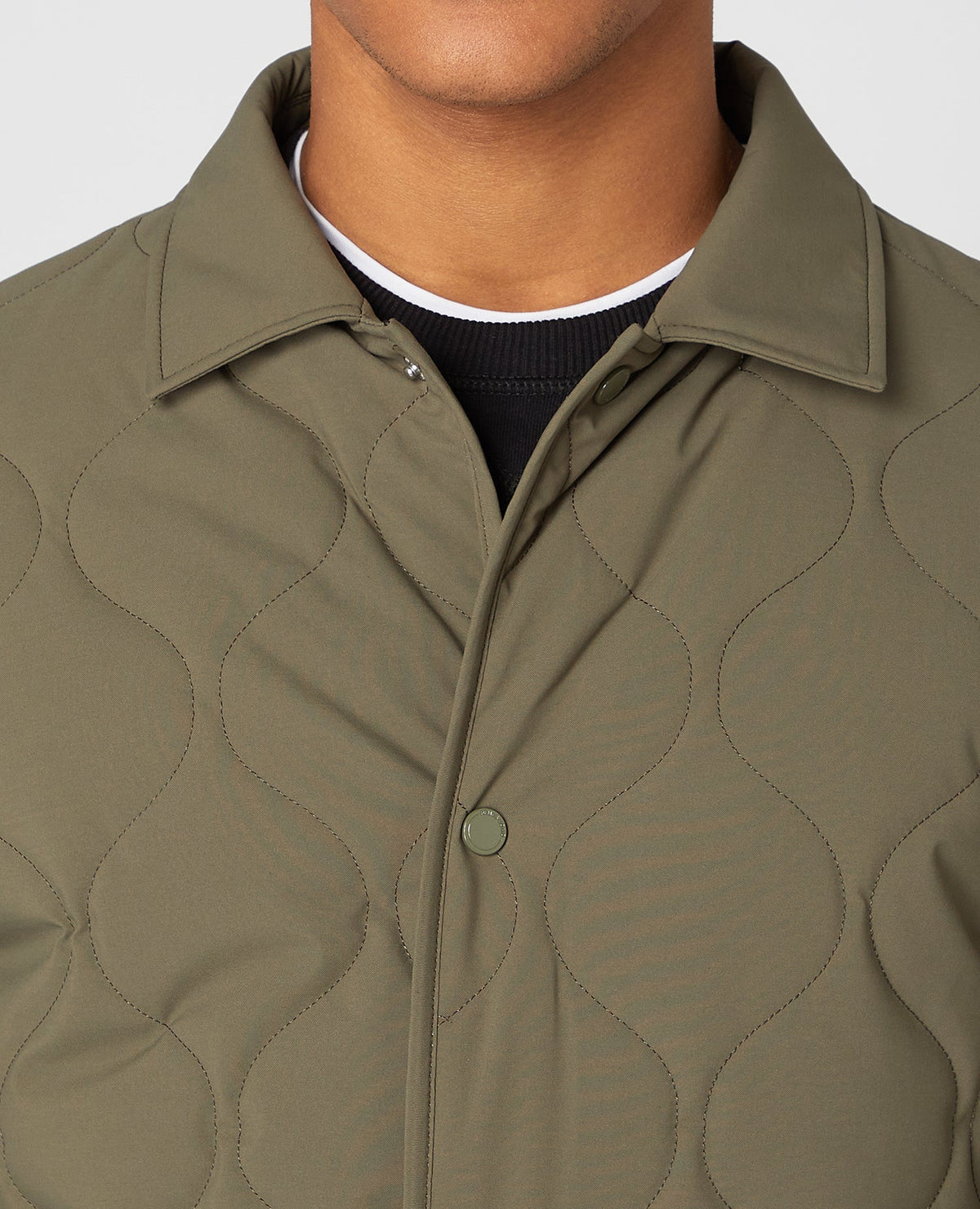 Man wearing a green Lightweight Quilted Overshirt