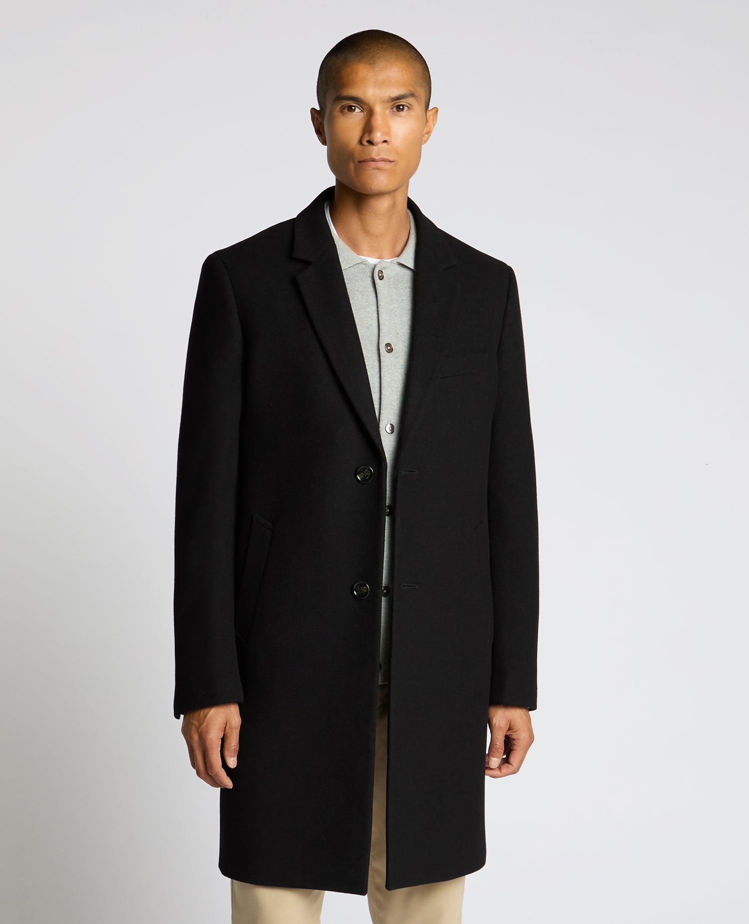 Man wearing a black Kayden Tailored Fit Chelsea Overcoat