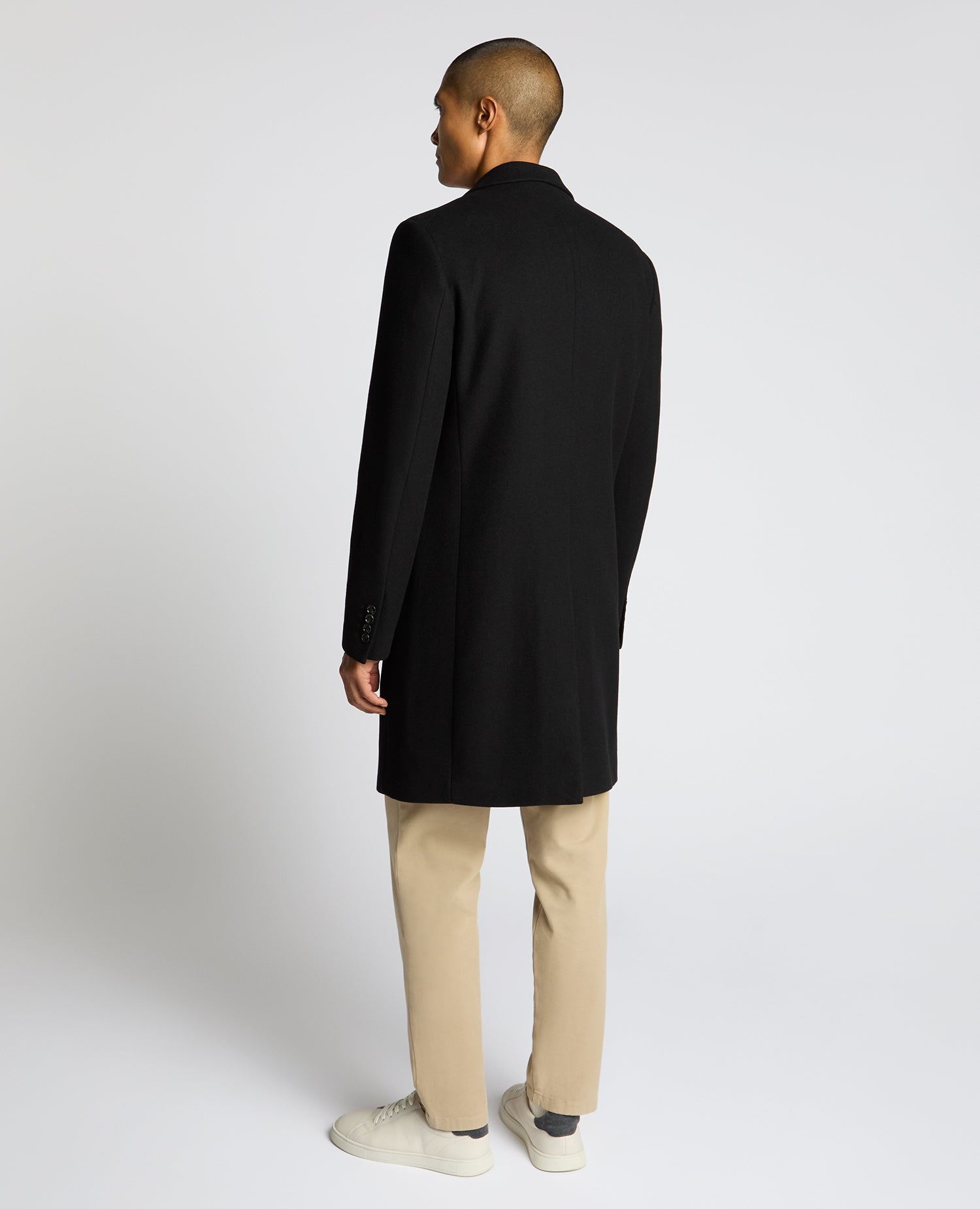 Man wearing a black Kayden Tailored Fit Chelsea Overcoat