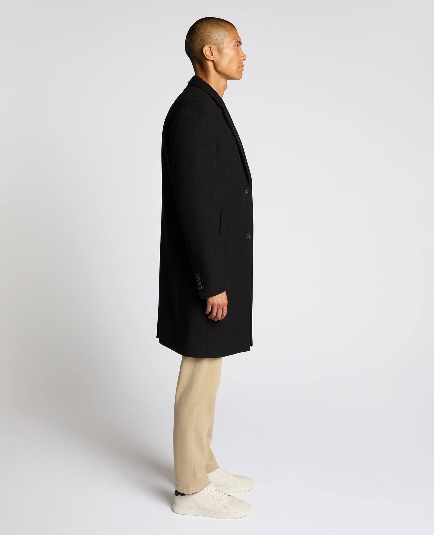 Man wearing a black Kayden Tailored Fit Chelsea Overcoat