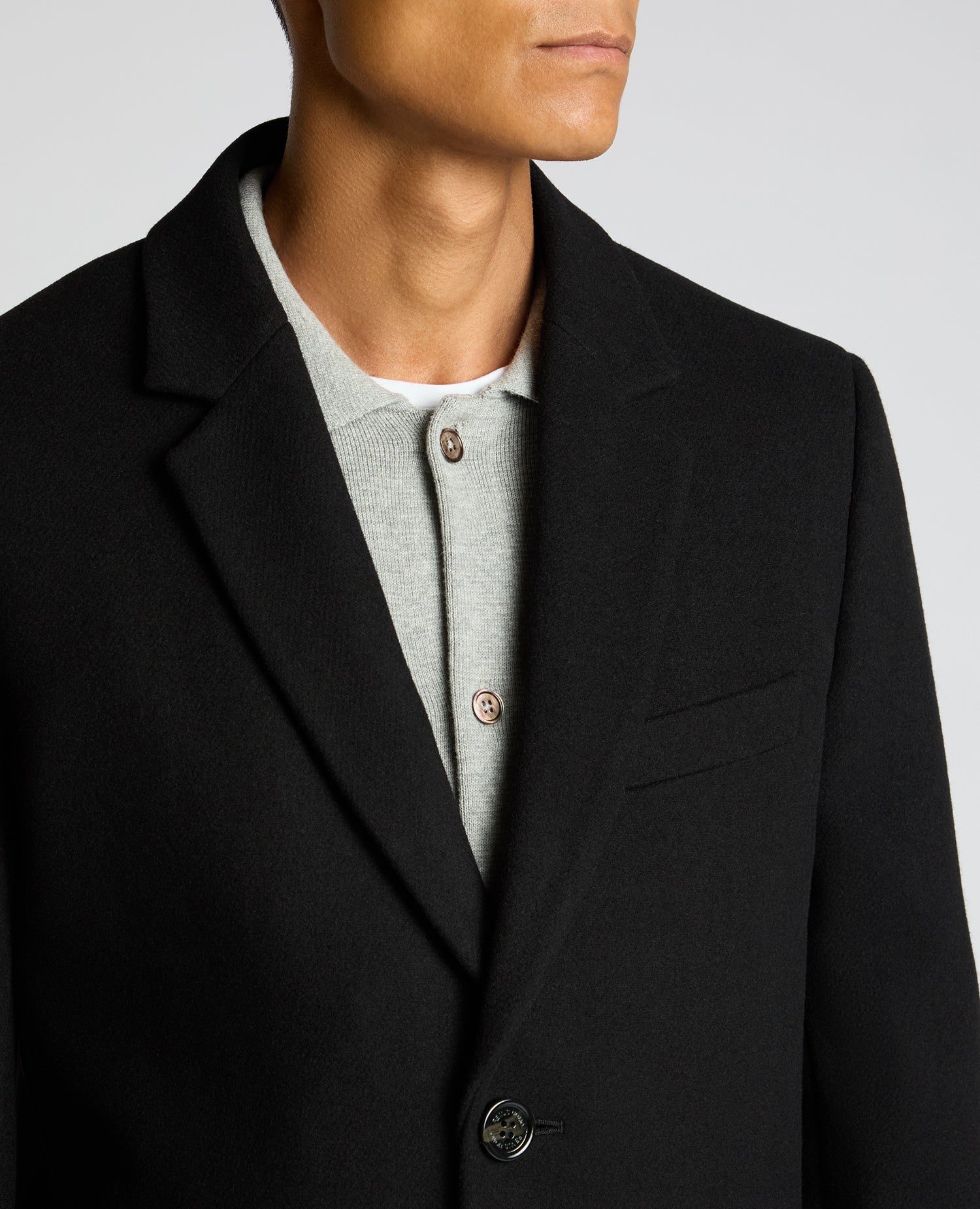 Man wearing a black Kayden Tailored Fit Chelsea Overcoat