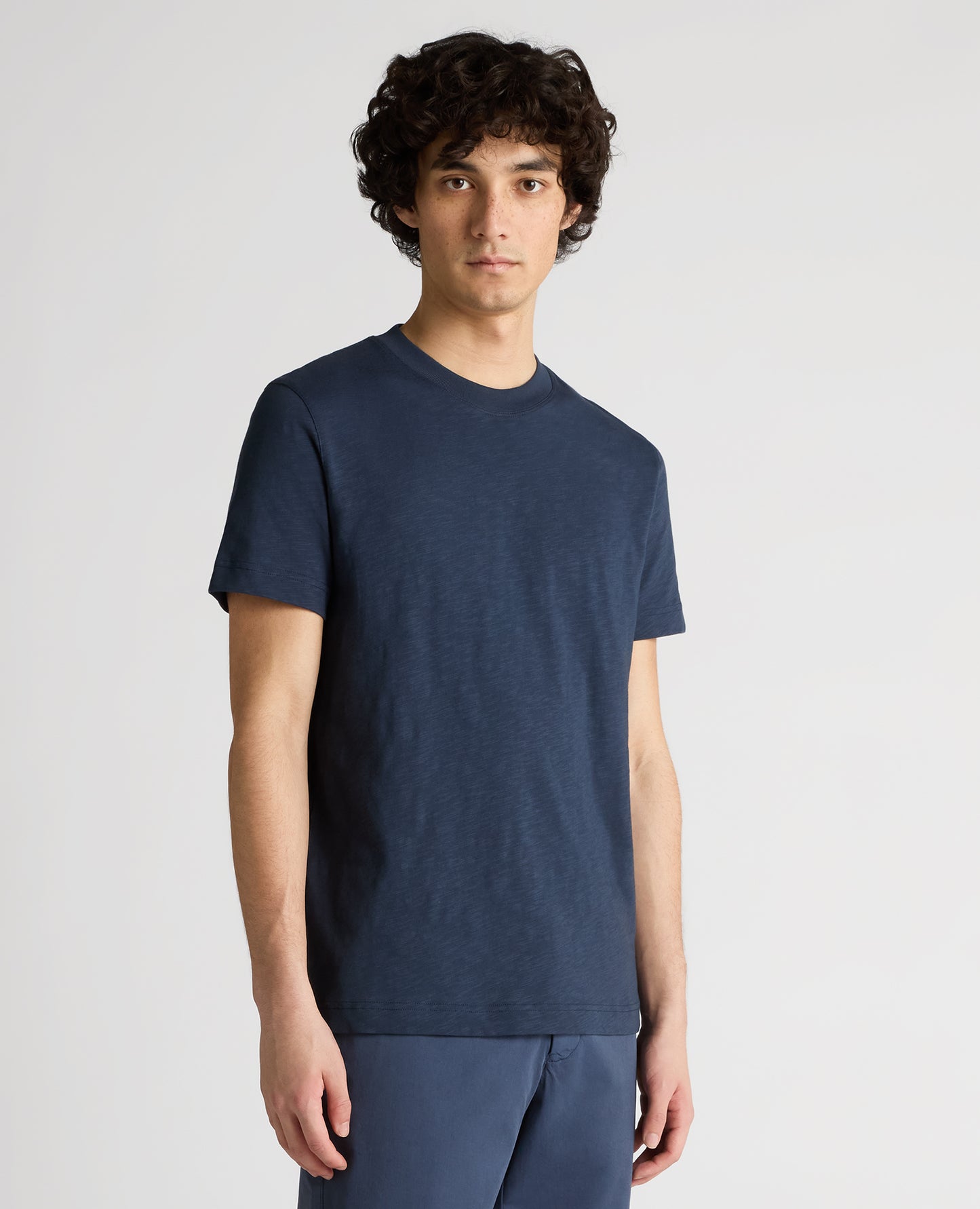 Man wearing a navy Tapered Fit Cotton Crew Neck Tee