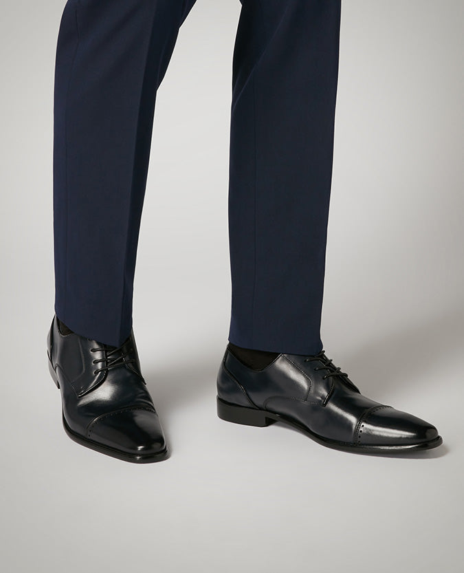 Man wearing a navy Leather Bonucci Shoe