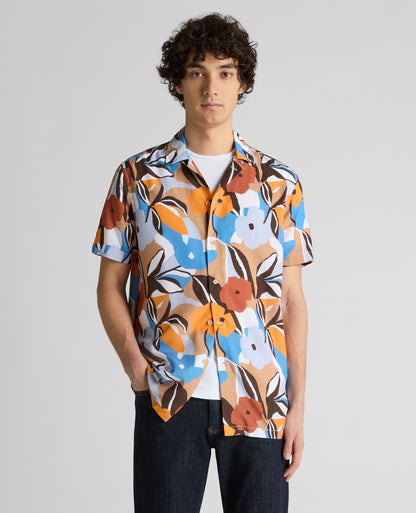 Man wearing a blue Tapered Fit Tencel Floral Print shirt