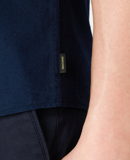 Man wearing a navy Slim Fit Oxford Cotton Short Sleeve Shirt
