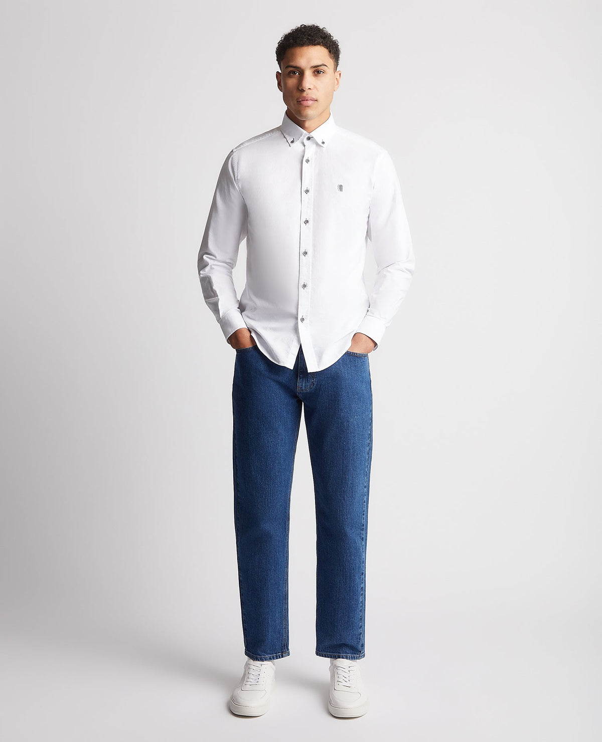Man wearing a white Tapered Fit Oxford Cotton Shirt