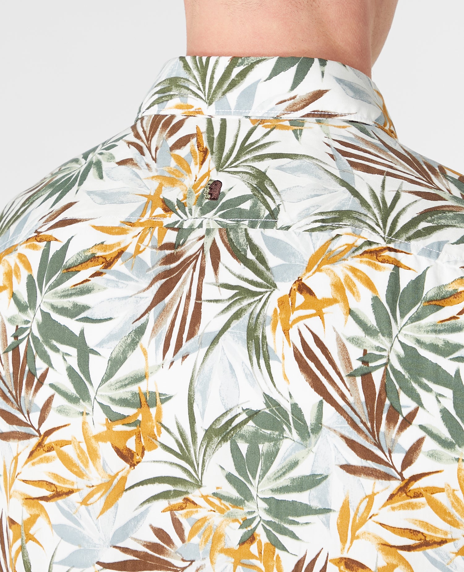Man wearing a white and brown casual shirt