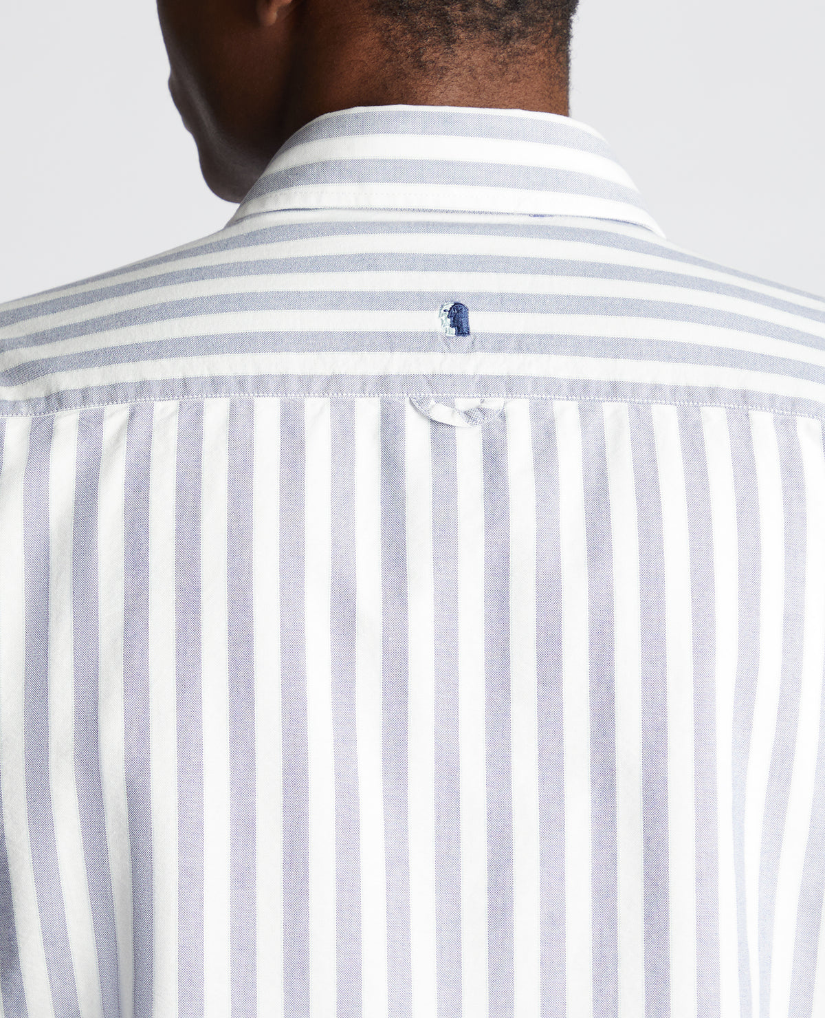 Man wearing a navy Tapered Fit Striped Cotton Shirt