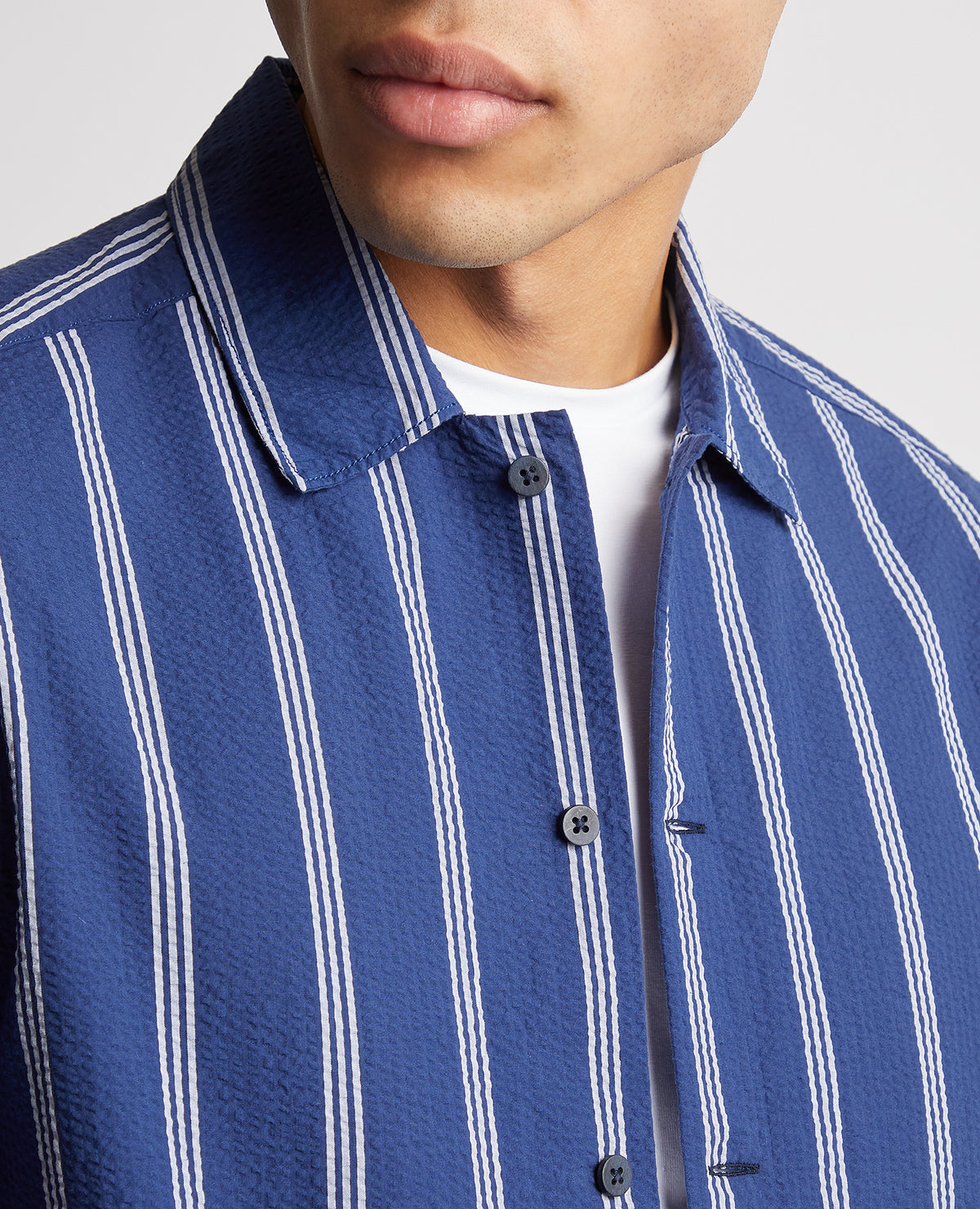 Man wearing a blue Tapered Fit Cotton Short Sleeve Shirt