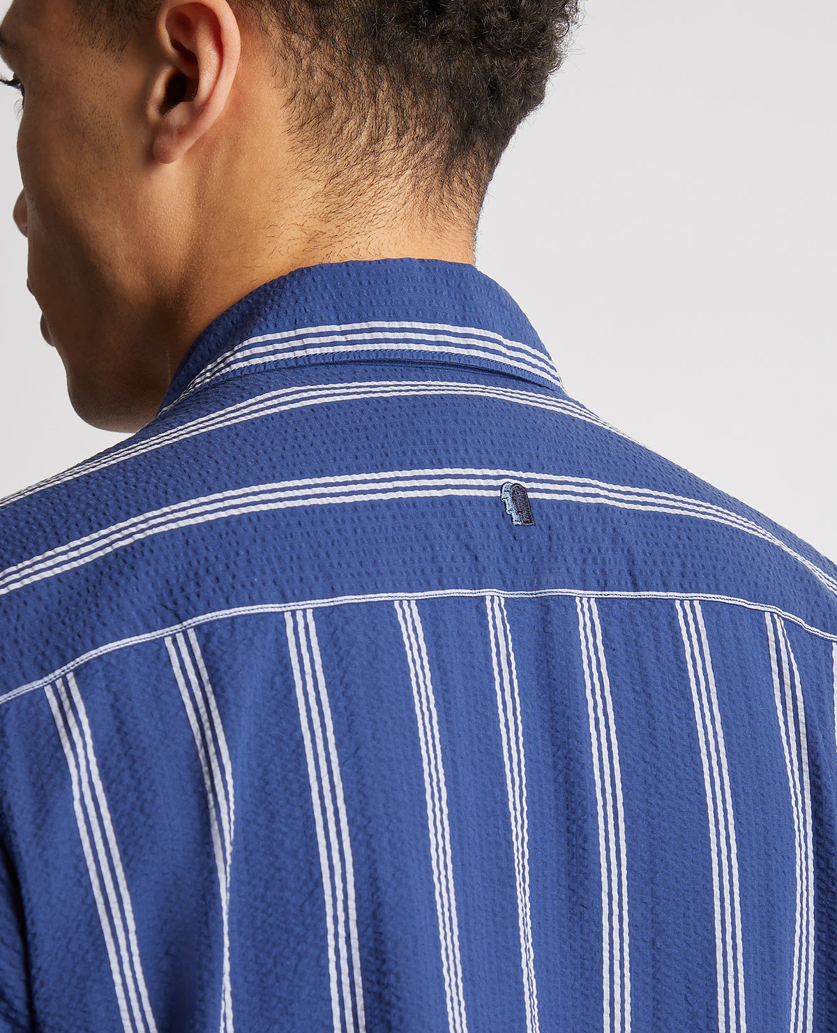 Man wearing a blue Tapered Fit Cotton Short Sleeve Shirt